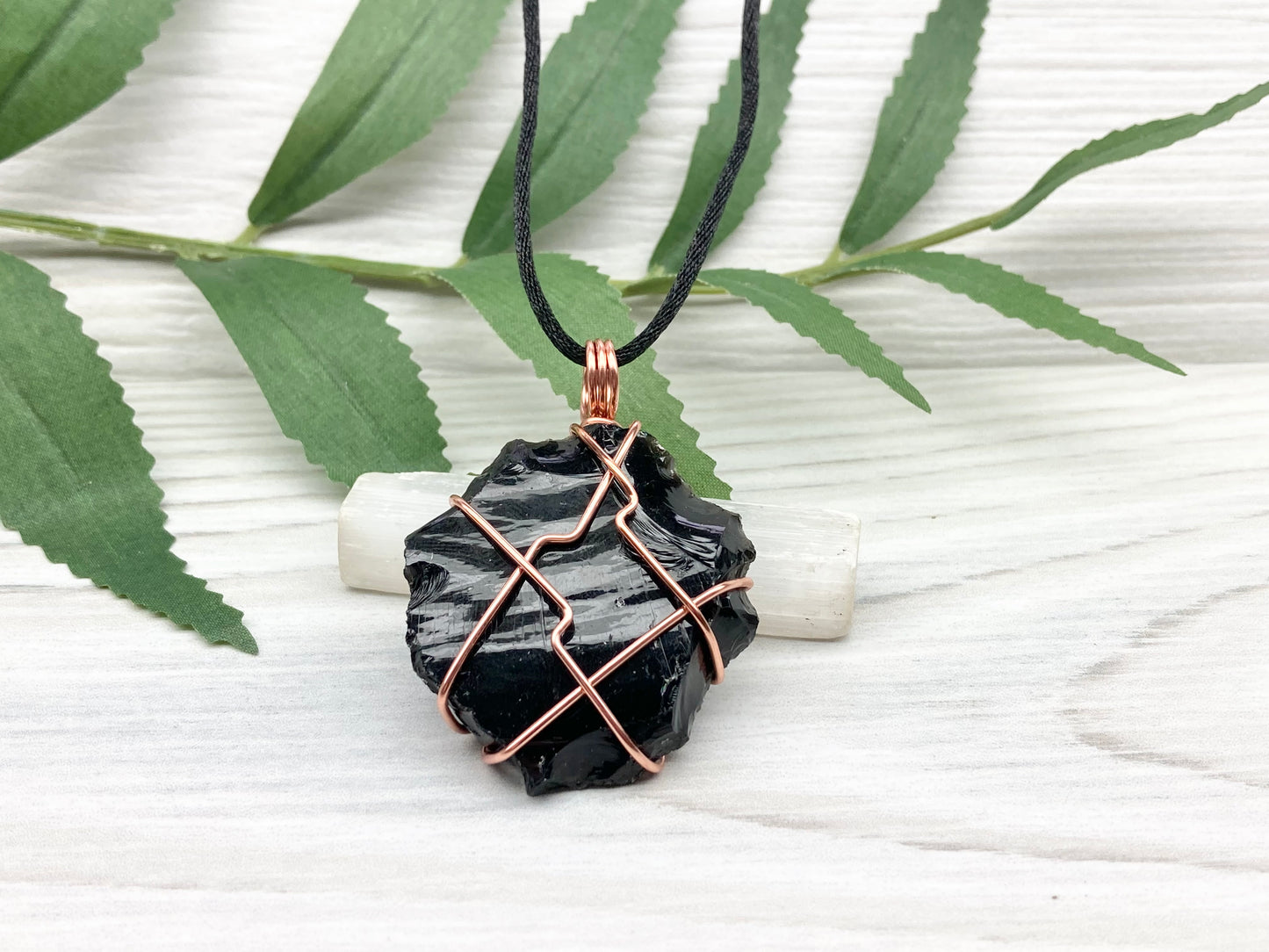 Raw black obsidian necklace. Natural black crystal wrapped with copper wire. Comes on a black necklace.