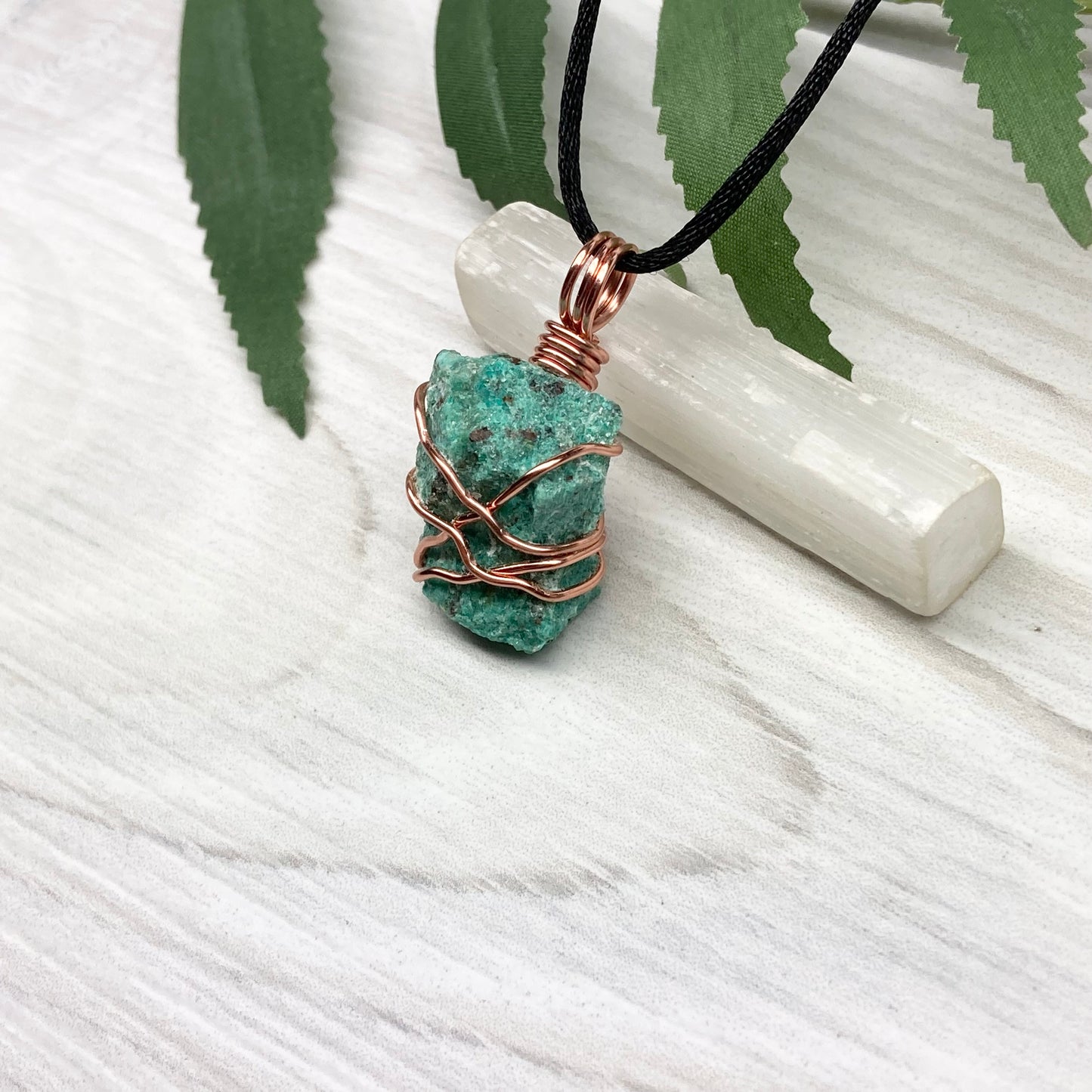 Chrysocolla necklace. Raw blue green stone wrapped in copper wire. Pendant hangs on a satin silk chain.