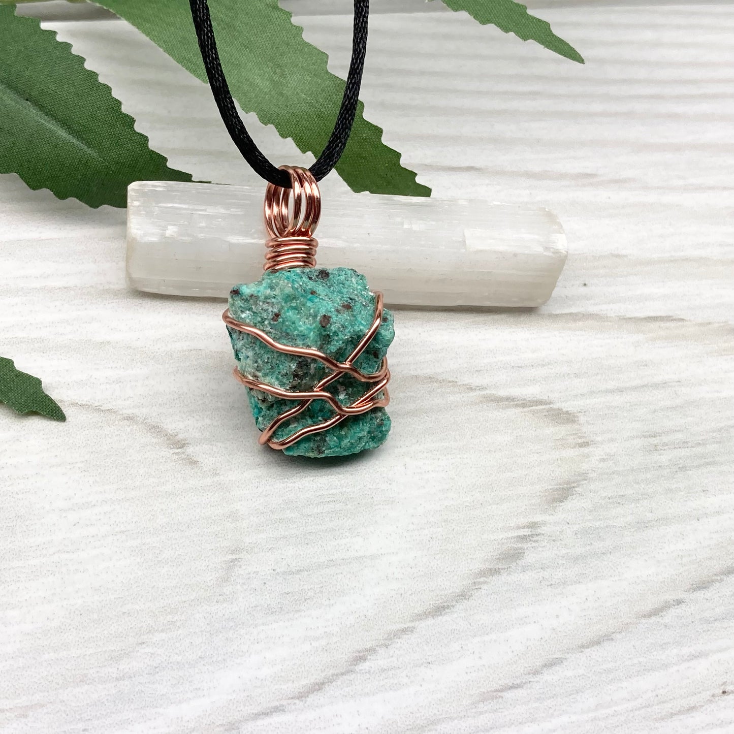 Chrysocolla necklace. Raw blue green stone wrapped in copper wire. Pendant hangs on a satin silk chain.