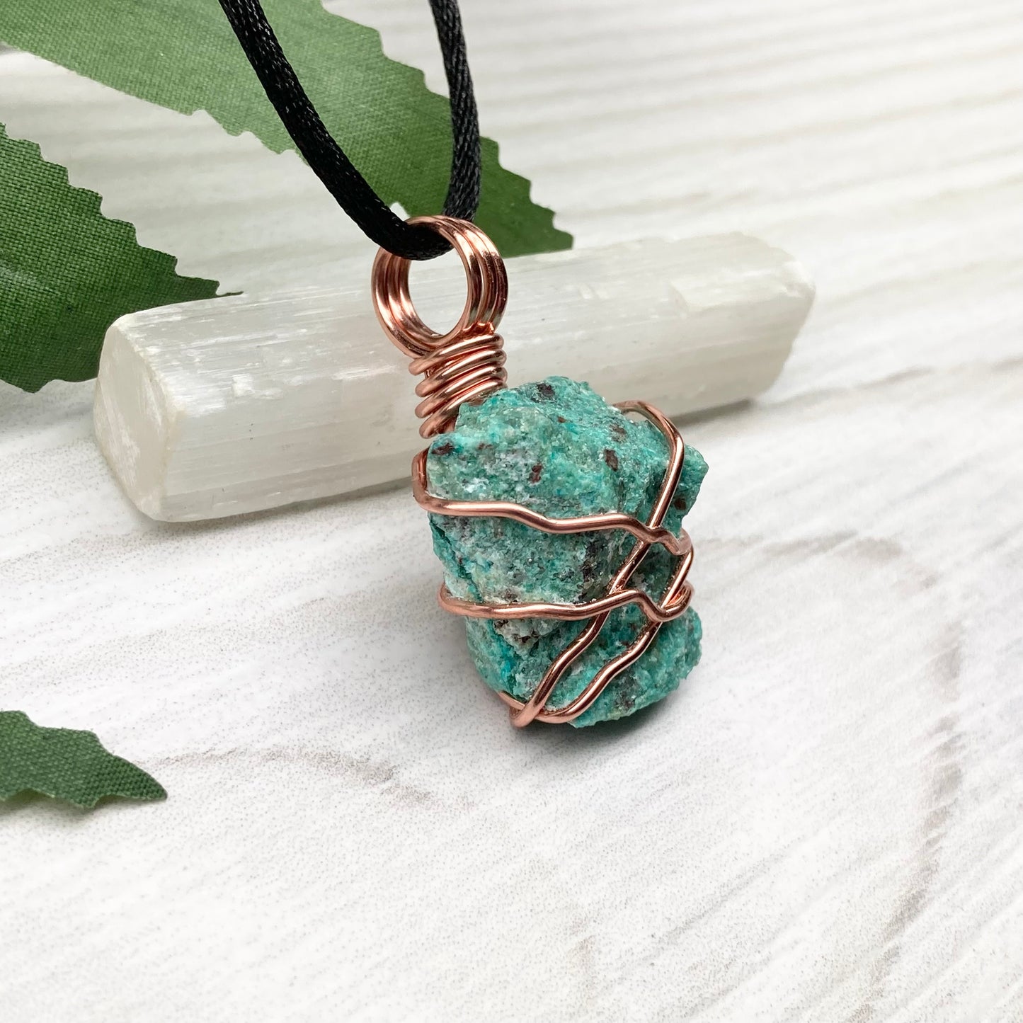 Chrysocolla necklace. Raw blue green stone wrapped in copper wire. Pendant hangs on a satin silk chain.