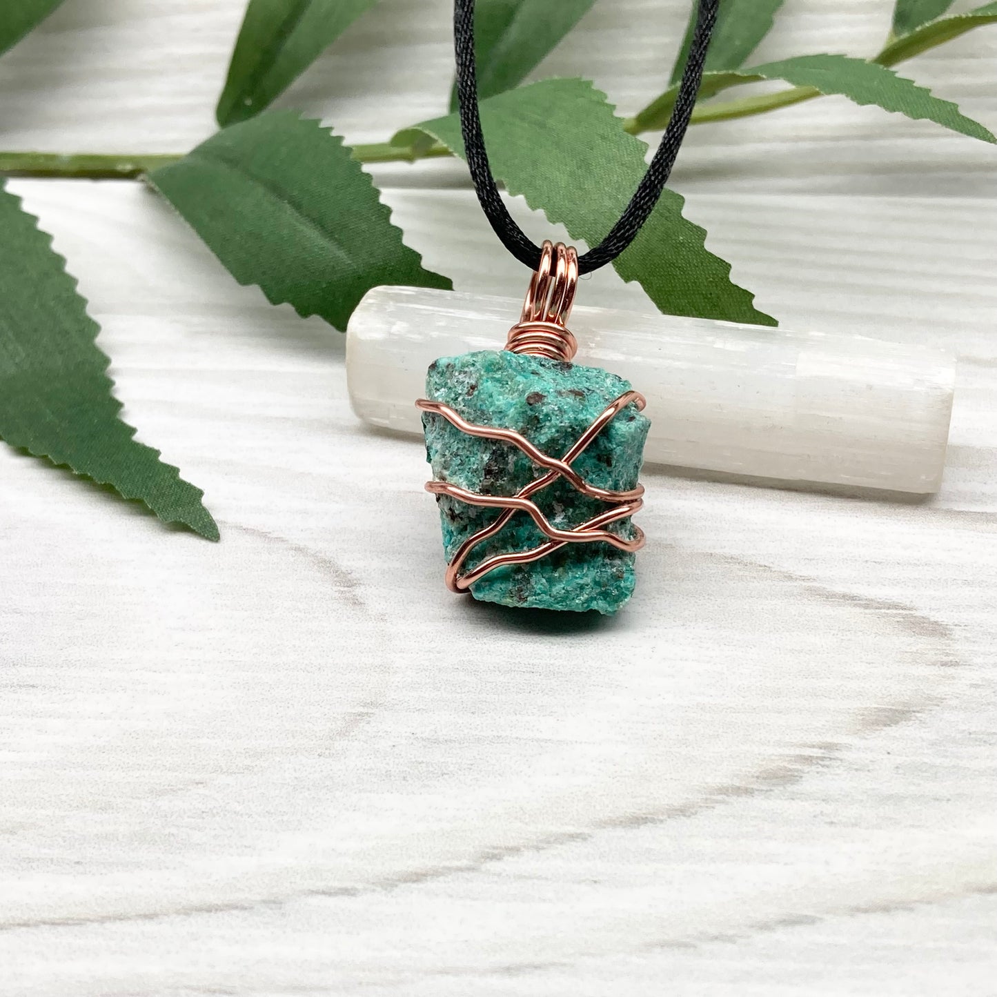 Chrysocolla necklace. Raw blue green stone wrapped in copper wire. Pendant hangs on a satin silk chain.