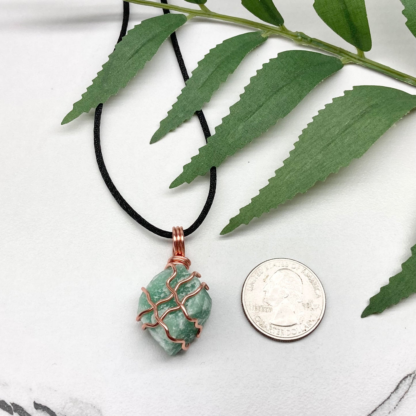 Green Aventurine Necklace. Raw Green Aventurine crystal wrapped with copper wire. Comes on a black chain.