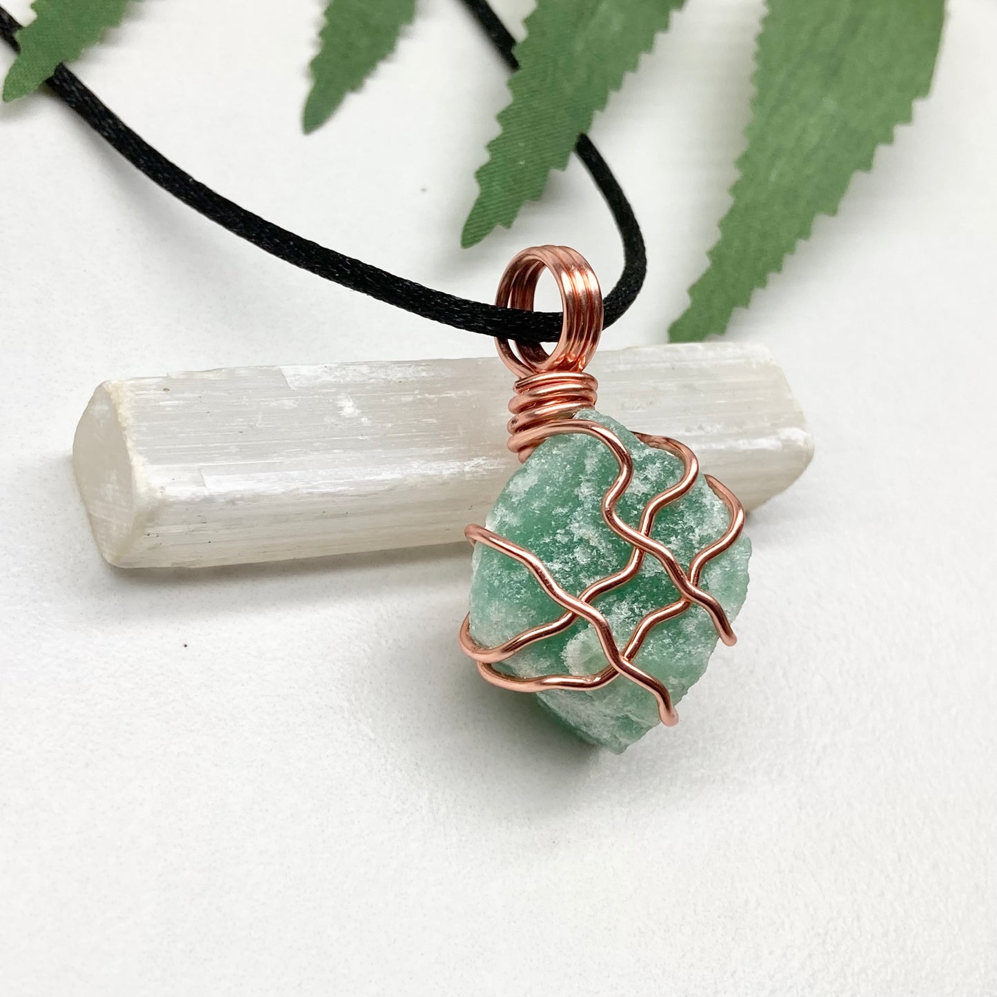 Green Aventurine Necklace. Raw Green Aventurine crystal wrapped with copper wire. Comes on a black chain.