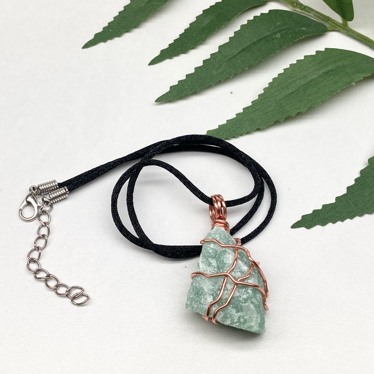 Green Aventurine necklace. Green stone wrapped with copper wire. Comes on a black chain. Hanfcrafted metaphysical jewelry.
