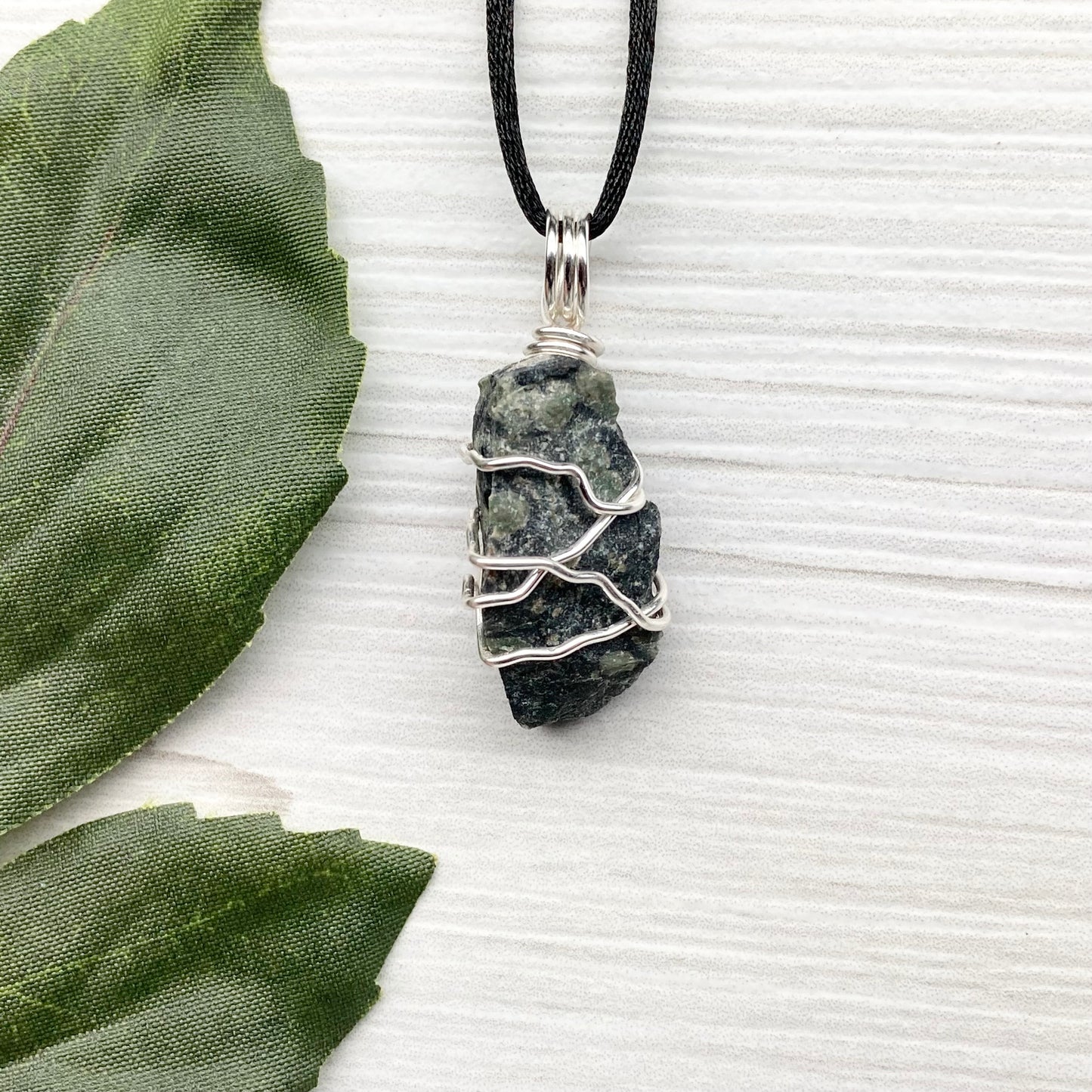 Kambaba Jasper necklace. Raw Kambaba Jasper stone wrapped with silver colored copper wire. Hangs on a black satin silk chain. Wire wrapped green and black crystal copper pendant. Handcrafted metaphysical jewelry.