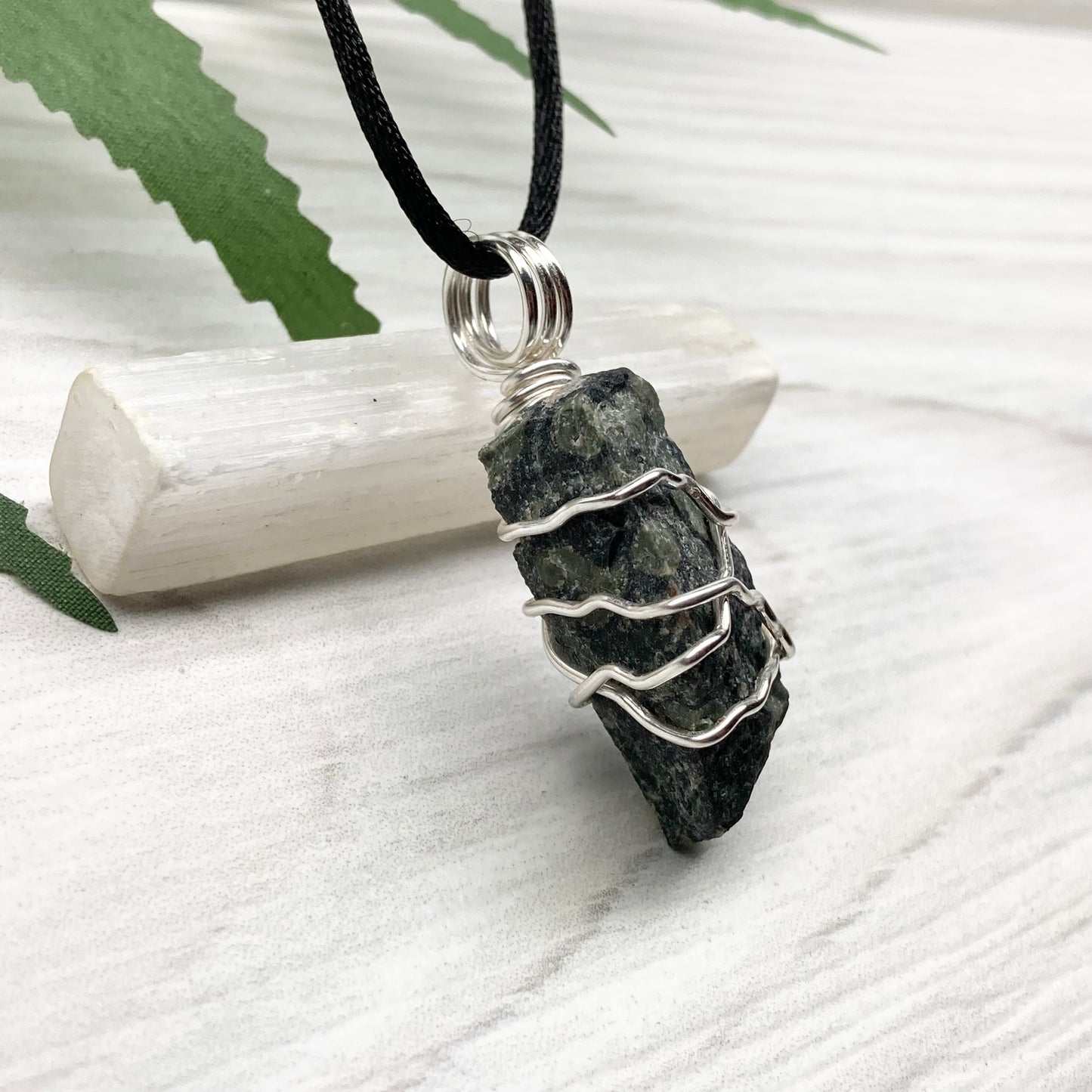 Kambaba Jasper necklace. Raw Kambaba Jasper stone wrapped with silver colored copper wire. Hangs on a black satin silk chain. Wire wrapped green and black crystal copper pendant. Handcrafted metaphysical jewelry.