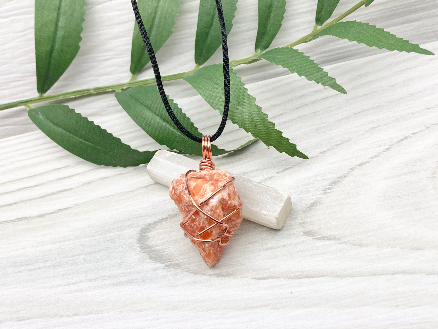 Orange Calcite Necklace. Raw Orange Calcite Crystal Wrapped With Copper Wire That Is Tarnish Resistant. Comes On A Black Necklace. Gemini Zodiac Stone Pendant. Handmade In Tennessee. Pagan Spiritual Jewelry.