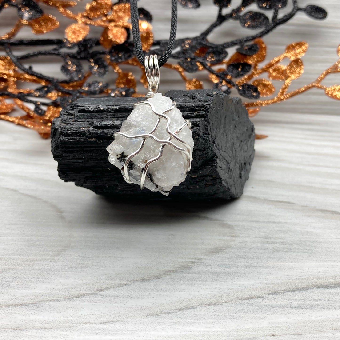 Rainbow Moonstone necklace. Raw Rainbow Moonstone wrapped with silver colored copper wire. Comes on a black chain. White and black crystal wire wrapped pendant. Water element jewelry.