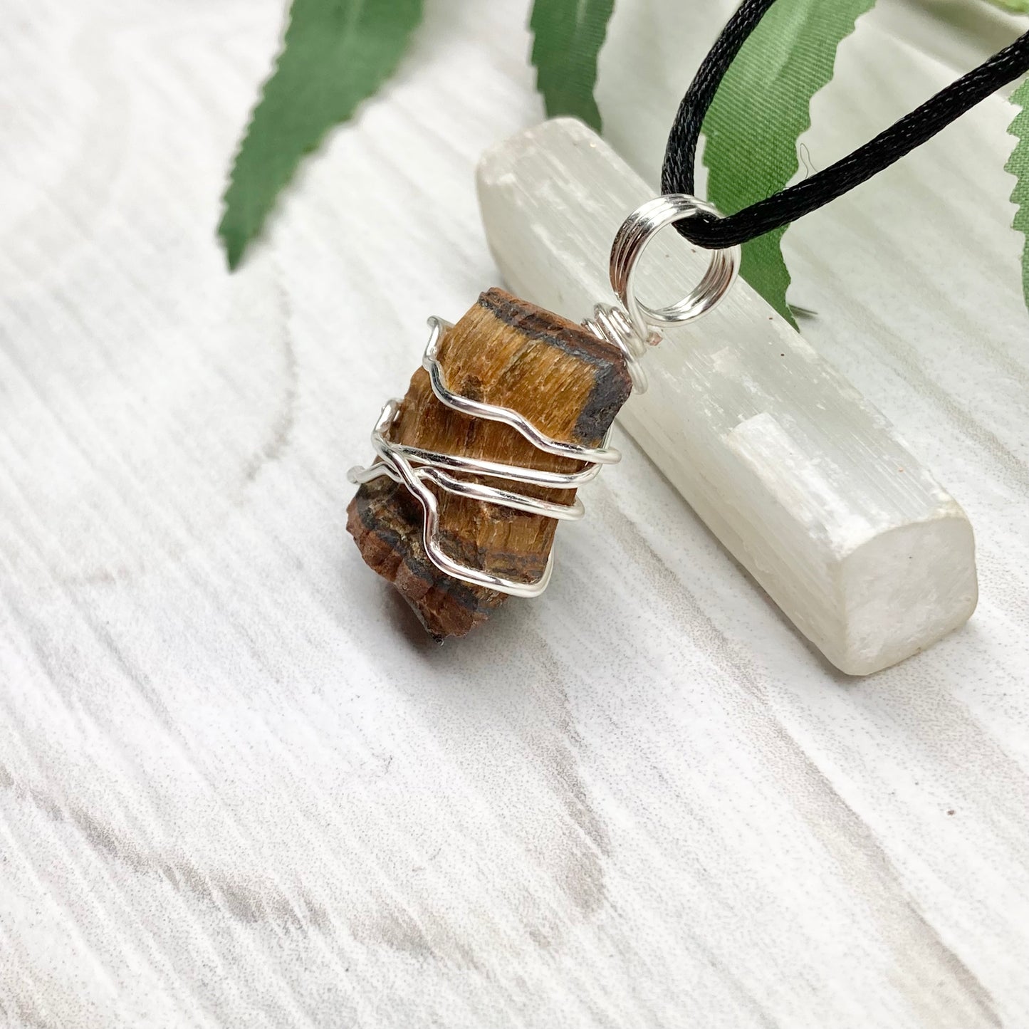 Tigers Eye necklace. Raw Tiger Eye stone wrapped with tarnish resistant silver copper wire. This stone is gold and brown. Unisex handmade pendant. Comes on a black chain with silver ends. Leo zodiac gift.
