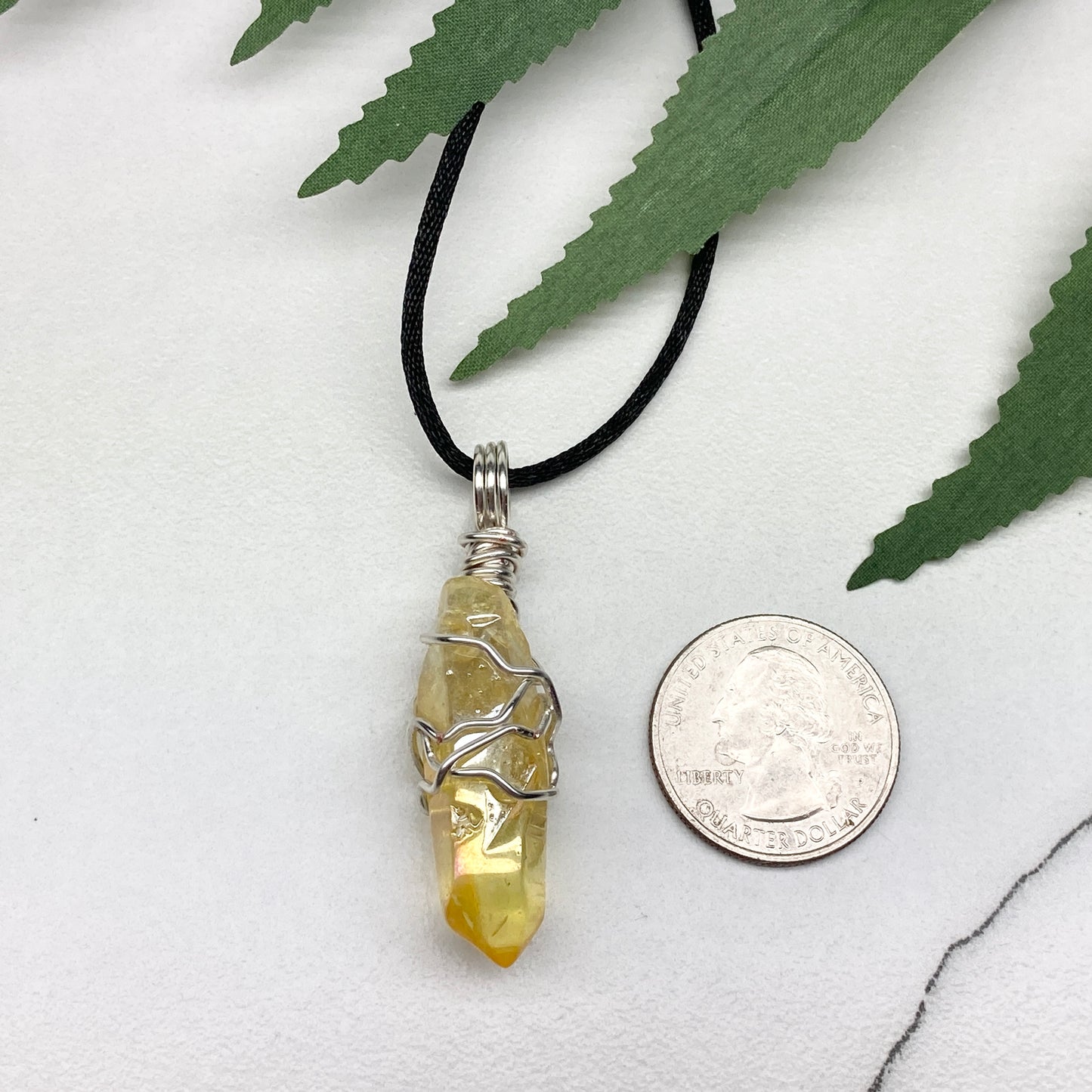 Yellow Aura Quartz necklace. Yellow crystal wrapped with silver colored copper wire. Hangs on a black chain. Handmade yellow stone pendant.