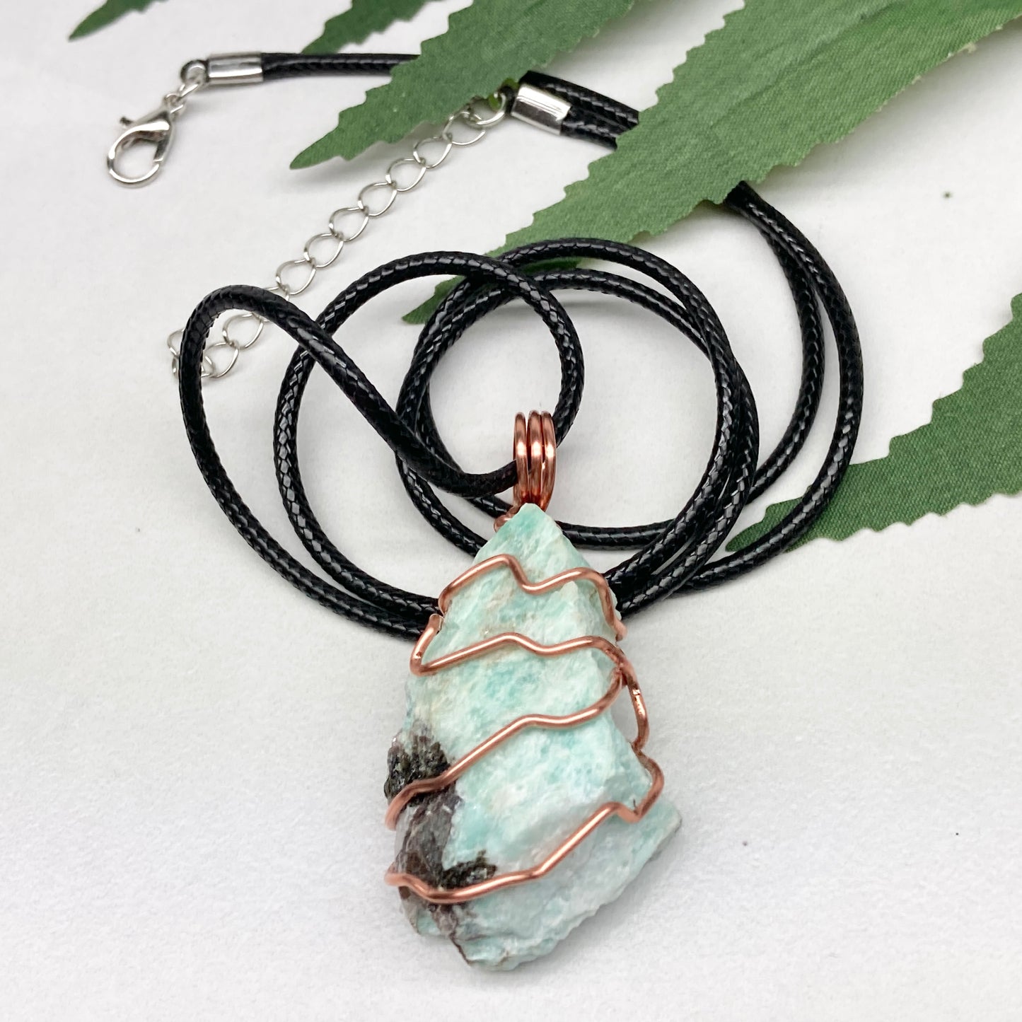 Amazonite necklace. Raw teal stone wrapped with copper wire. Hangs on a black chain. Real crystal pendant.