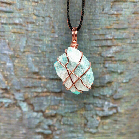 Handcrafted raw amazonite pendant wrapped in tarnish-resistant copper wire on a satin silk chain, light teal crystal measuring 1.8 by 1.1 inches.