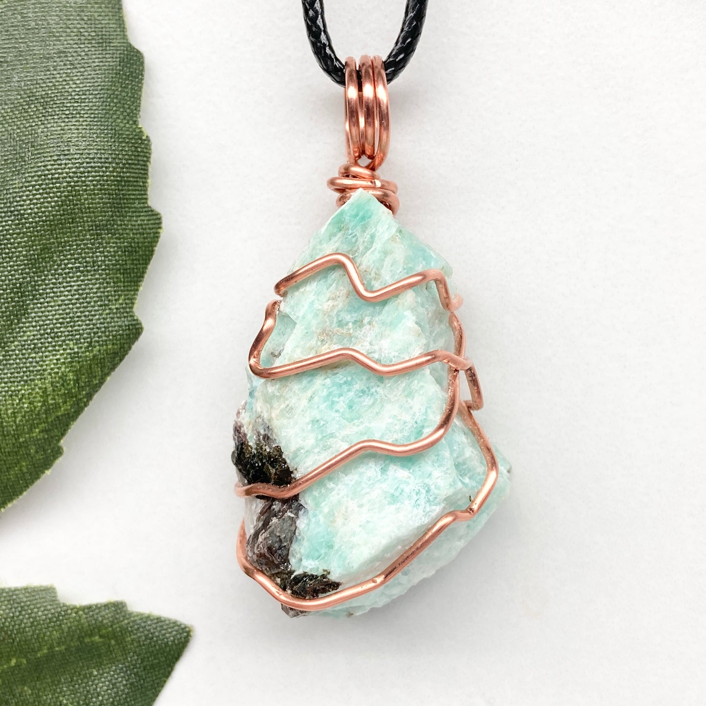 Amazonite necklace. Raw teal stone wrapped with copper wire. Hangs on a black chain. Real crystal pendant.