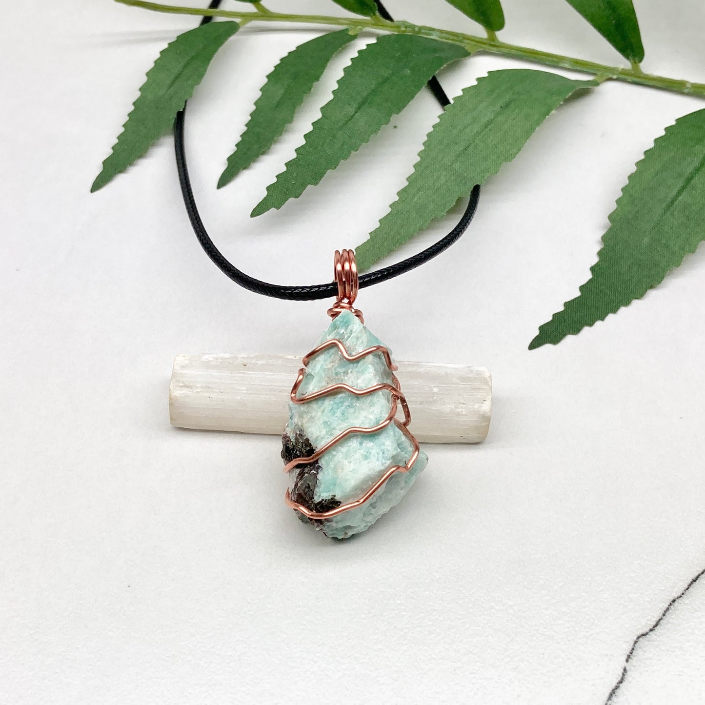 Amazonite necklace. Raw teal stone wrapped with copper wire. Hangs on a black chain. Real crystal pendant.