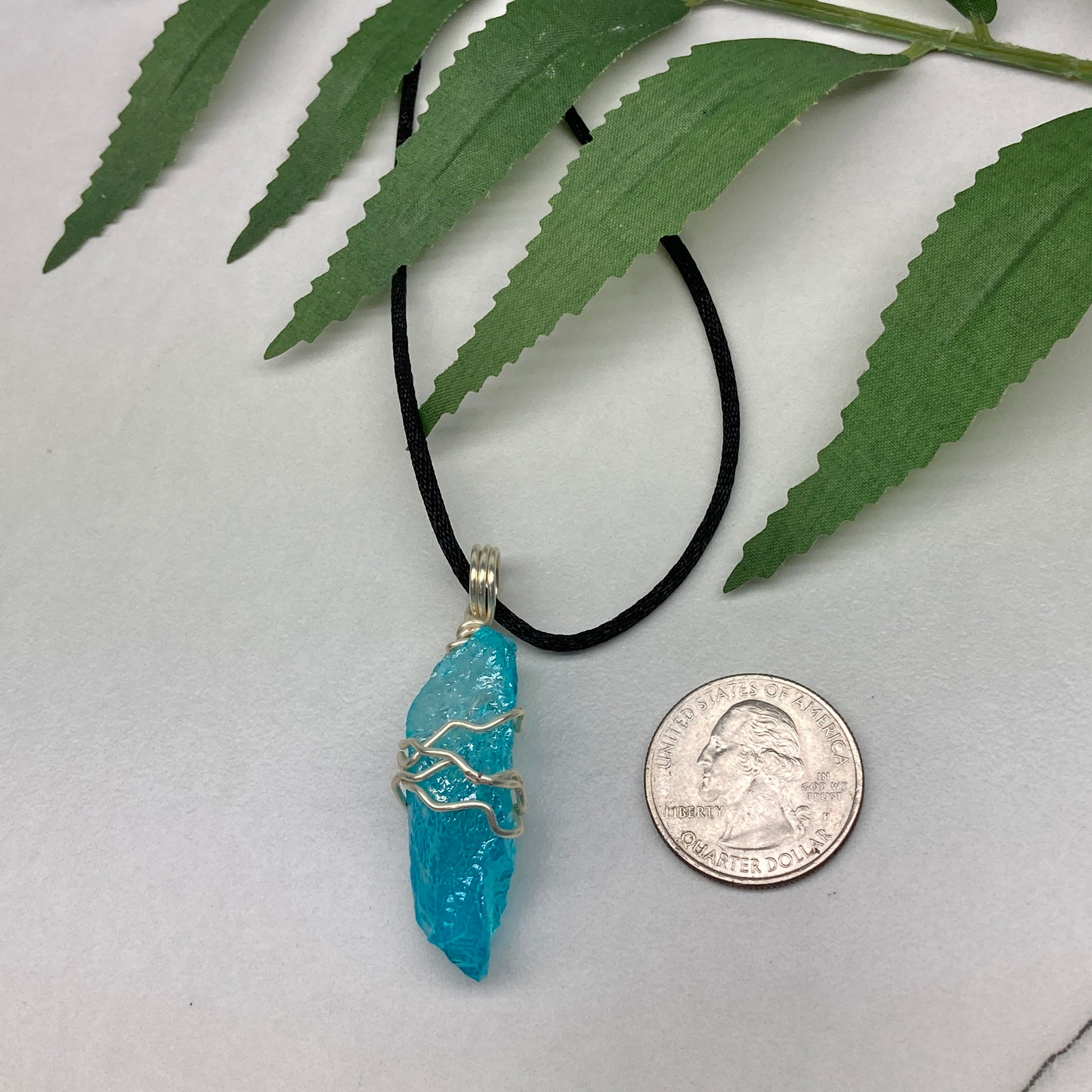 Aqua Aura Quartz crystal necklace wrapped in silver colored copper wire on a black satin silk necklace. Handmade during the Moon in Taurus.