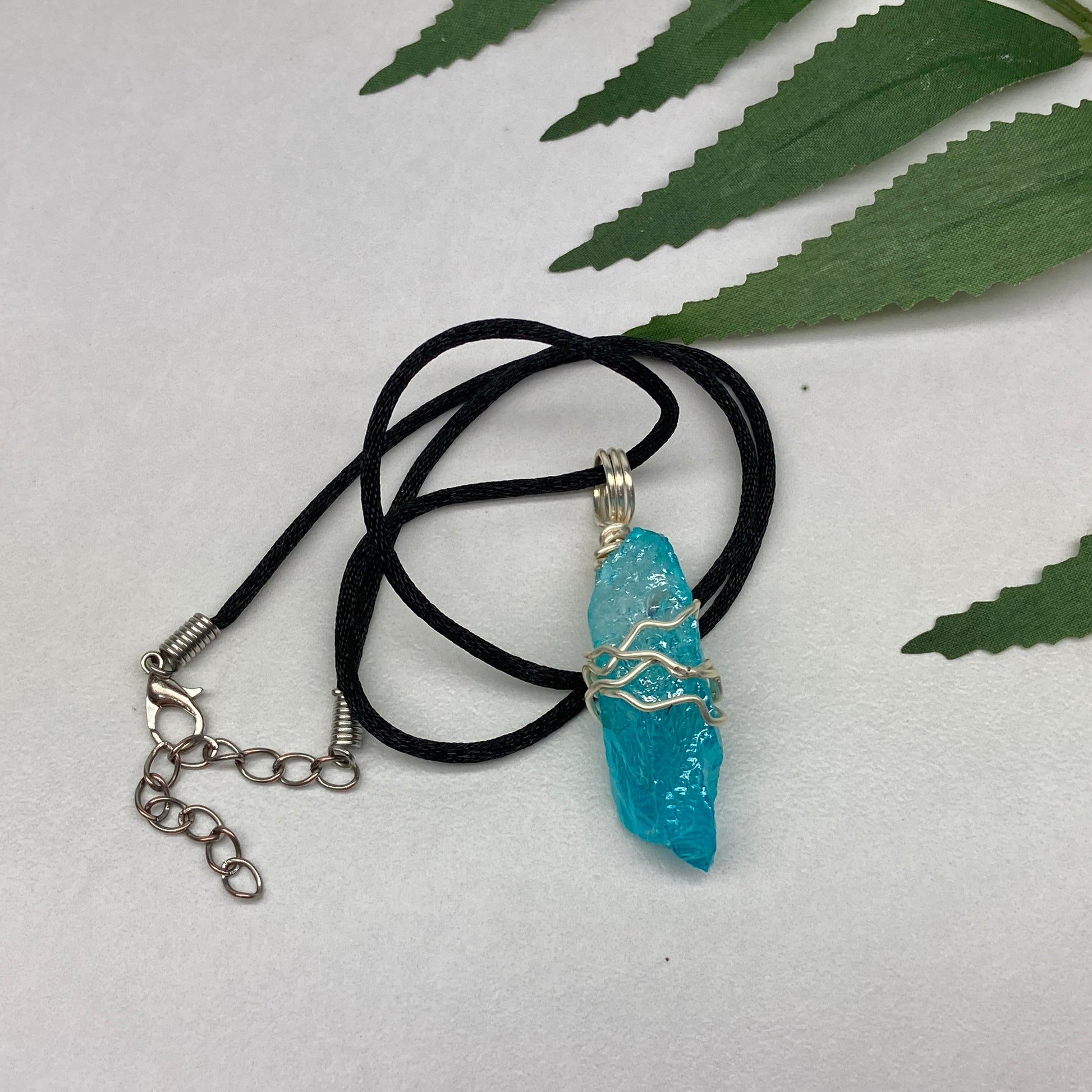 Aqua Aura Quartz crystal necklace wrapped in silver colored copper wire on a black satin silk necklace. Handmade during the Moon in Taurus.