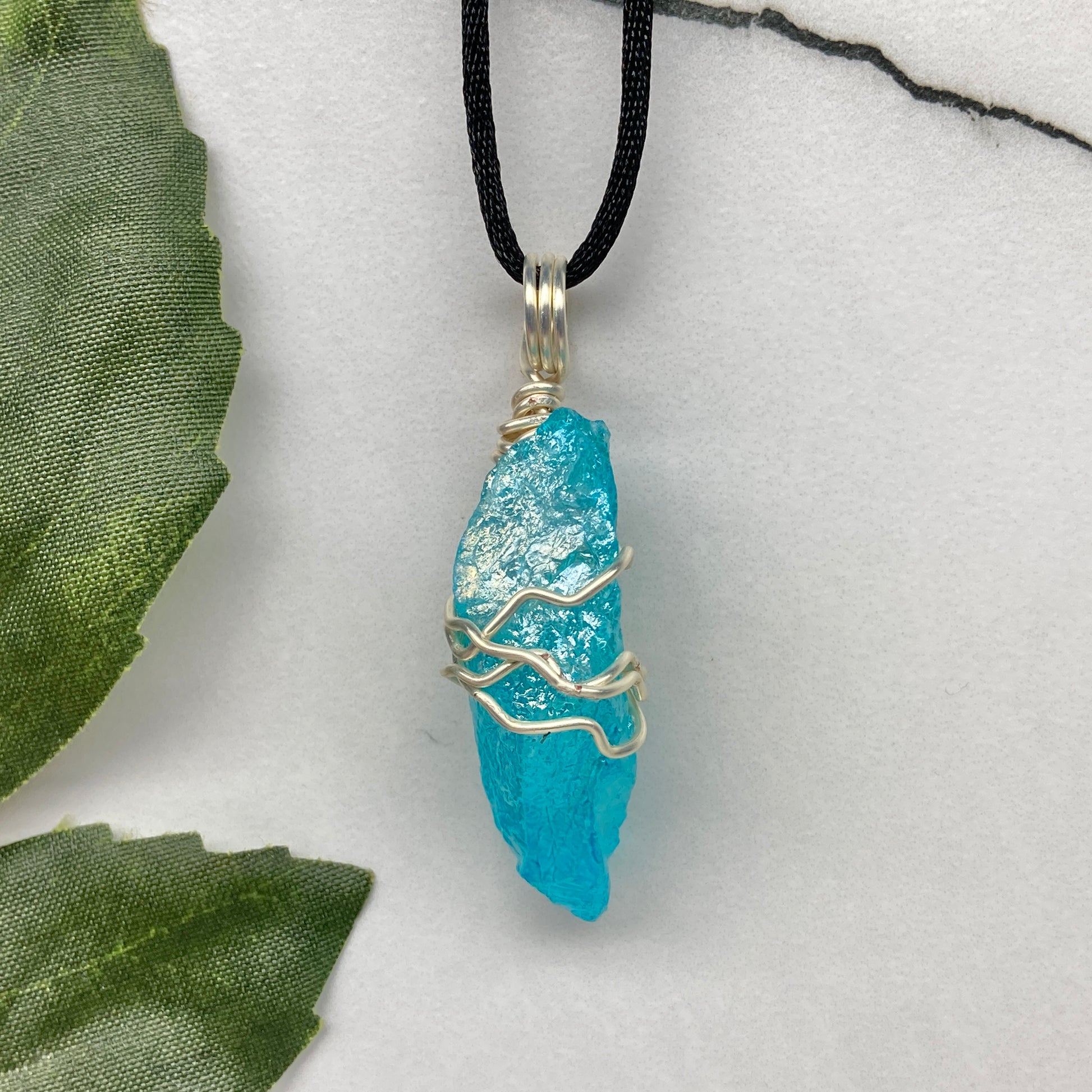 Aqua Aura Quartz crystal necklace wrapped in silver colored copper wire on a black satin silk necklace. Handmade during the Moon in Taurus.