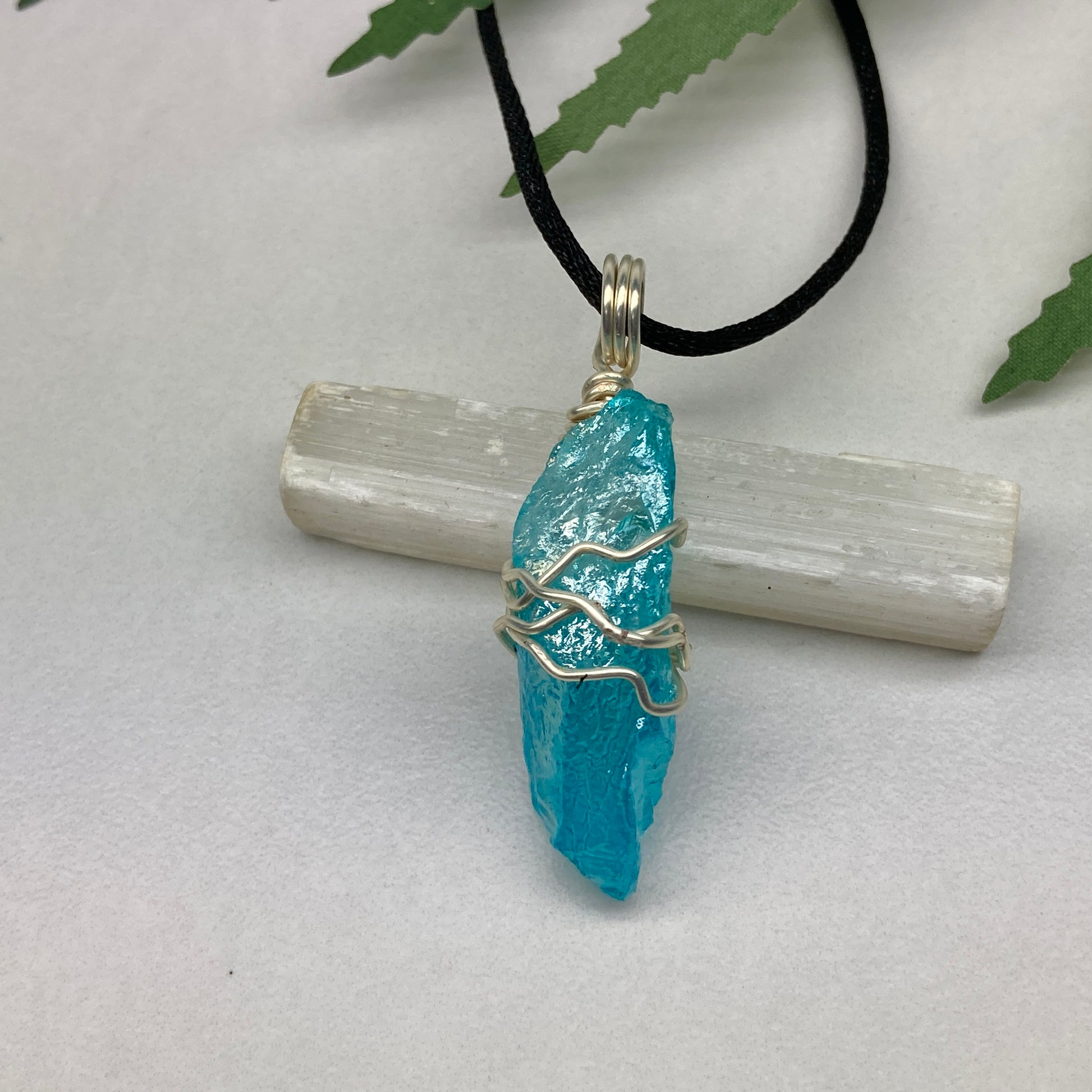 Aqua Aura Quartz crystal necklace wrapped in silver colored copper wire on a black satin silk necklace. Handmade during the Moon in Taurus.