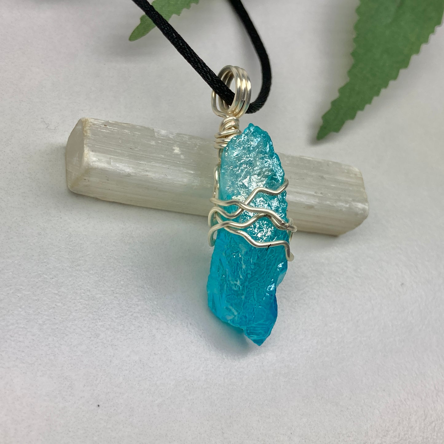 Aqua Aura Quartz crystal necklace wrapped in silver colored copper wire on a black satin silk necklace. Handmade during the Moon in Taurus.