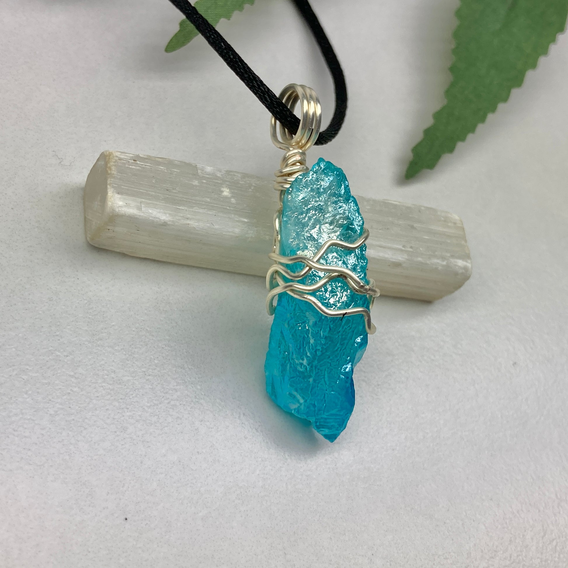 Aqua Aura Quartz crystal necklace wrapped in silver colored copper wire on a black satin silk necklace. Handmade during the Moon in Taurus.