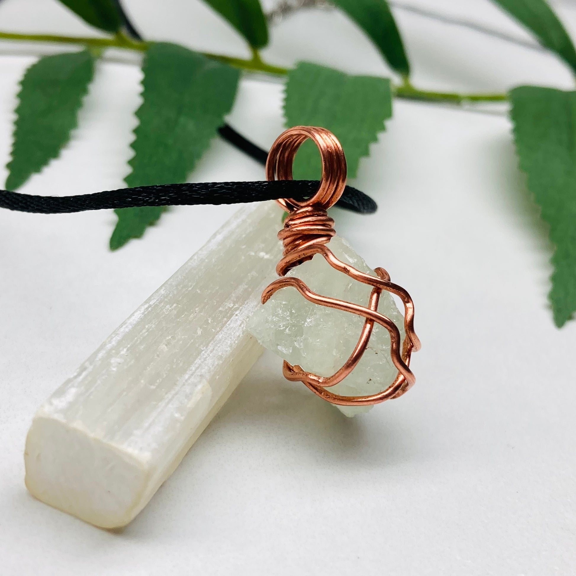 Aquamarine necklace. Raw light mint green stone wrapped with pure copper wire. Hangs on a black chain. Wire wrapped crystal jewelry.