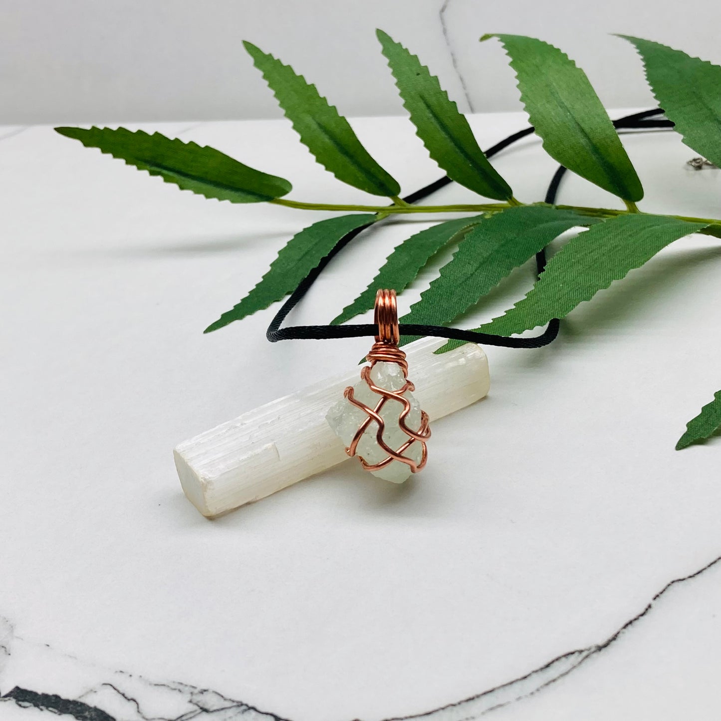 Aquamarine necklace. Raw light mint green stone wrapped with pure copper wire. Hangs on a black chain. Wire wrapped crystal jewelry.