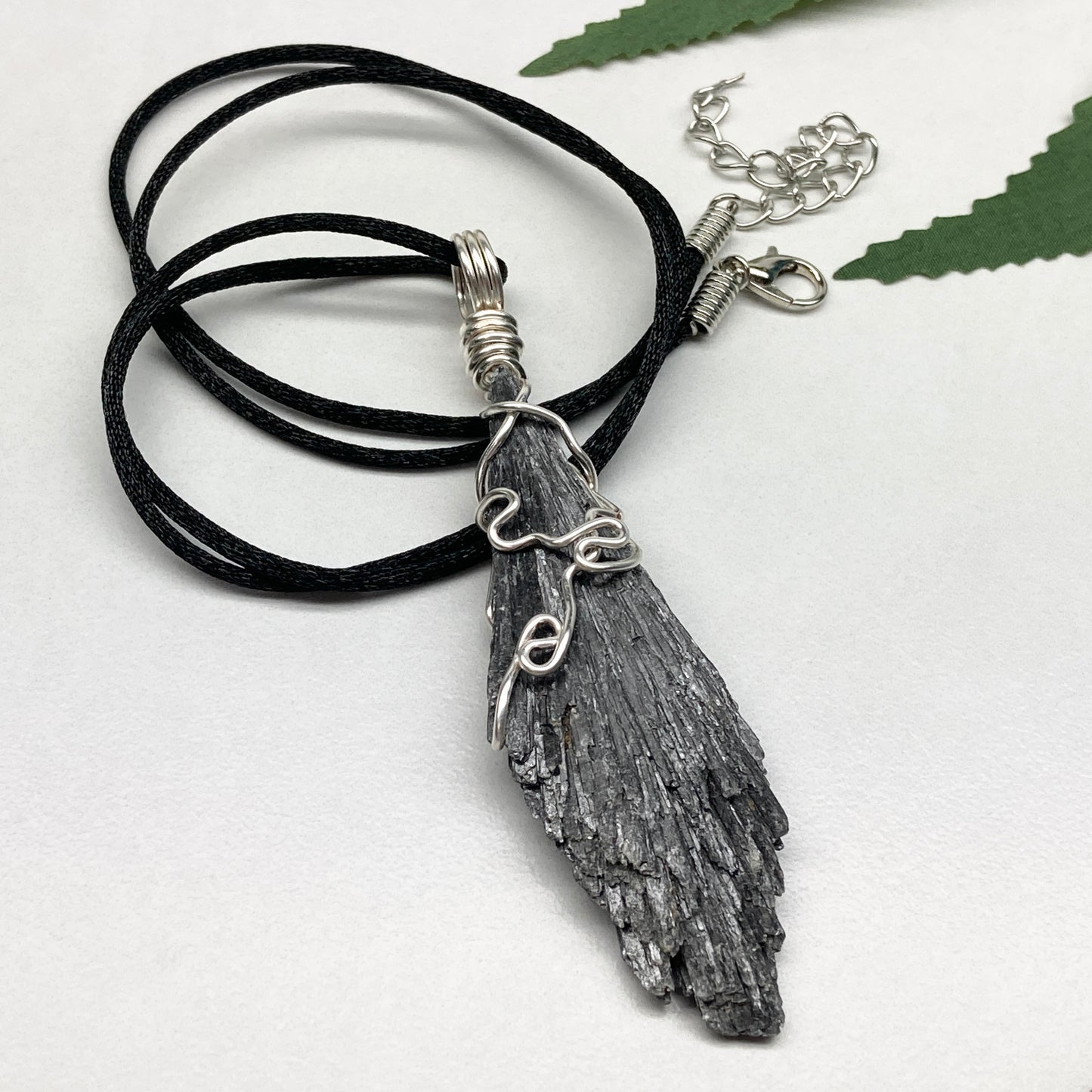 Black Kyanite necklace. Raw natural Kyanite wrapped with silver copper wire. Kyanite broom pendant. Black crystal jewelry. Comes on a black chain. Witchy gift.