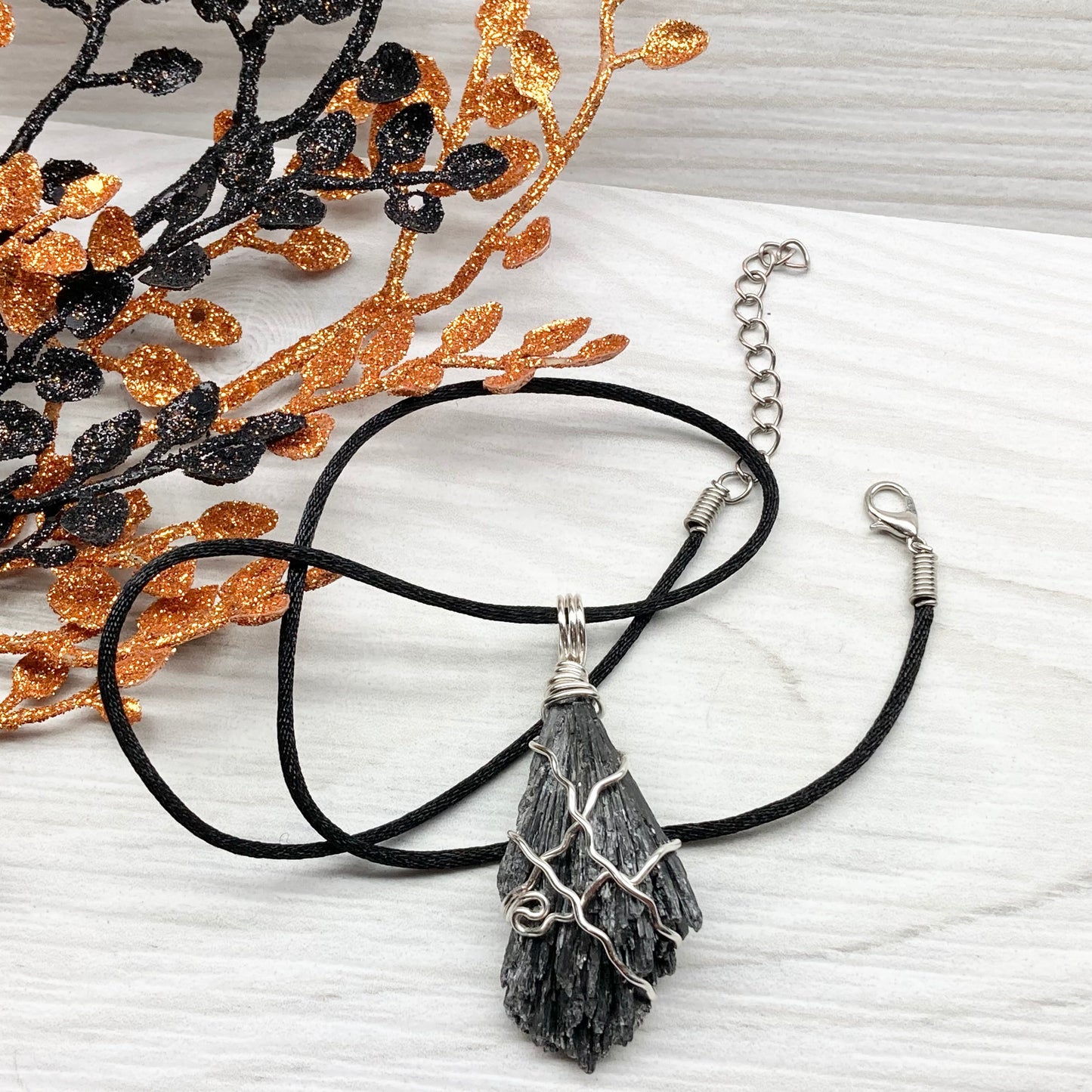 Black Kyanite necklace. Raw natural Kyanite wrapped with silver copper wire. Kyanite broom pendant. Black crystal jewelry. Comes on a black chain. Witchy gift.