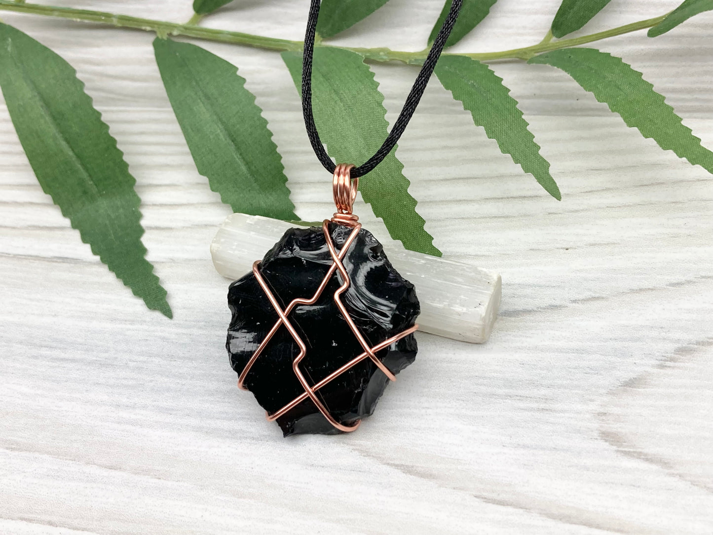Raw black obsidian necklace. Natural black crystal wrapped with copper wire. Comes on a black necklace.