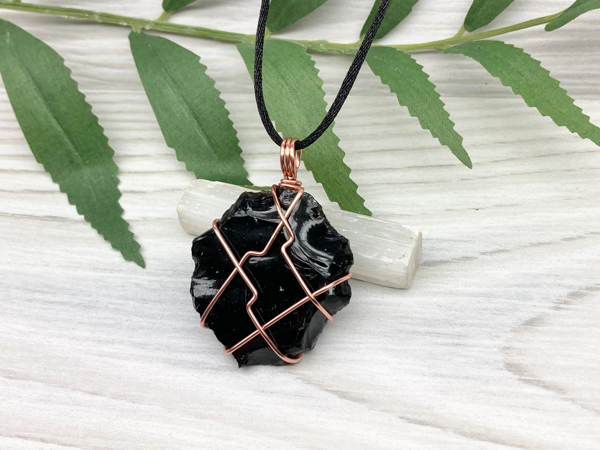 Raw black obsidian necklace. Natural black crystal wrapped with copper wire. Comes on a black necklace.