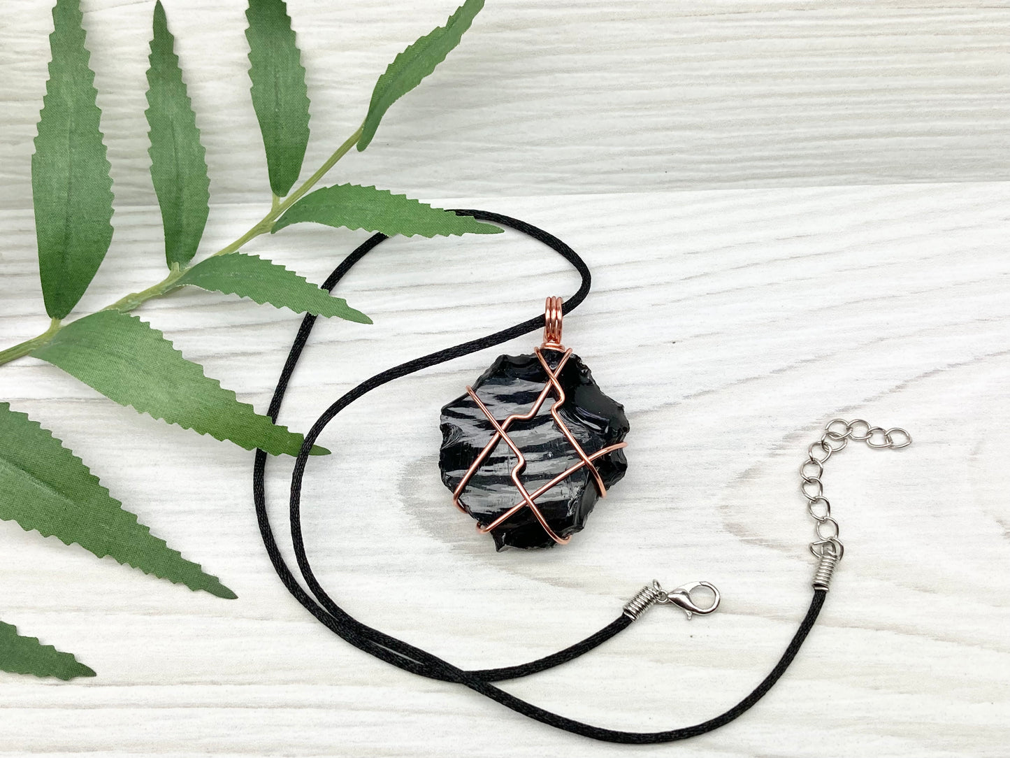 Raw black obsidian necklace. Natural black crystal wrapped with copper wire. Comes on a black necklace.