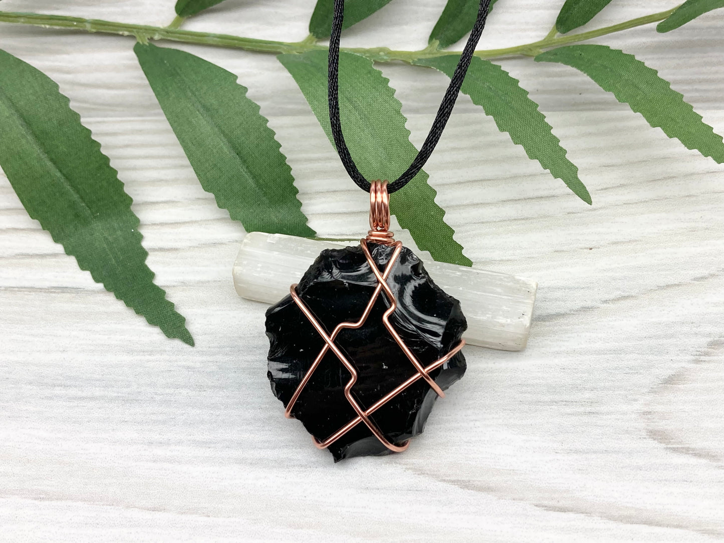 Raw black obsidian necklace. Natural black crystal wrapped with copper wire. Comes on a black necklace.