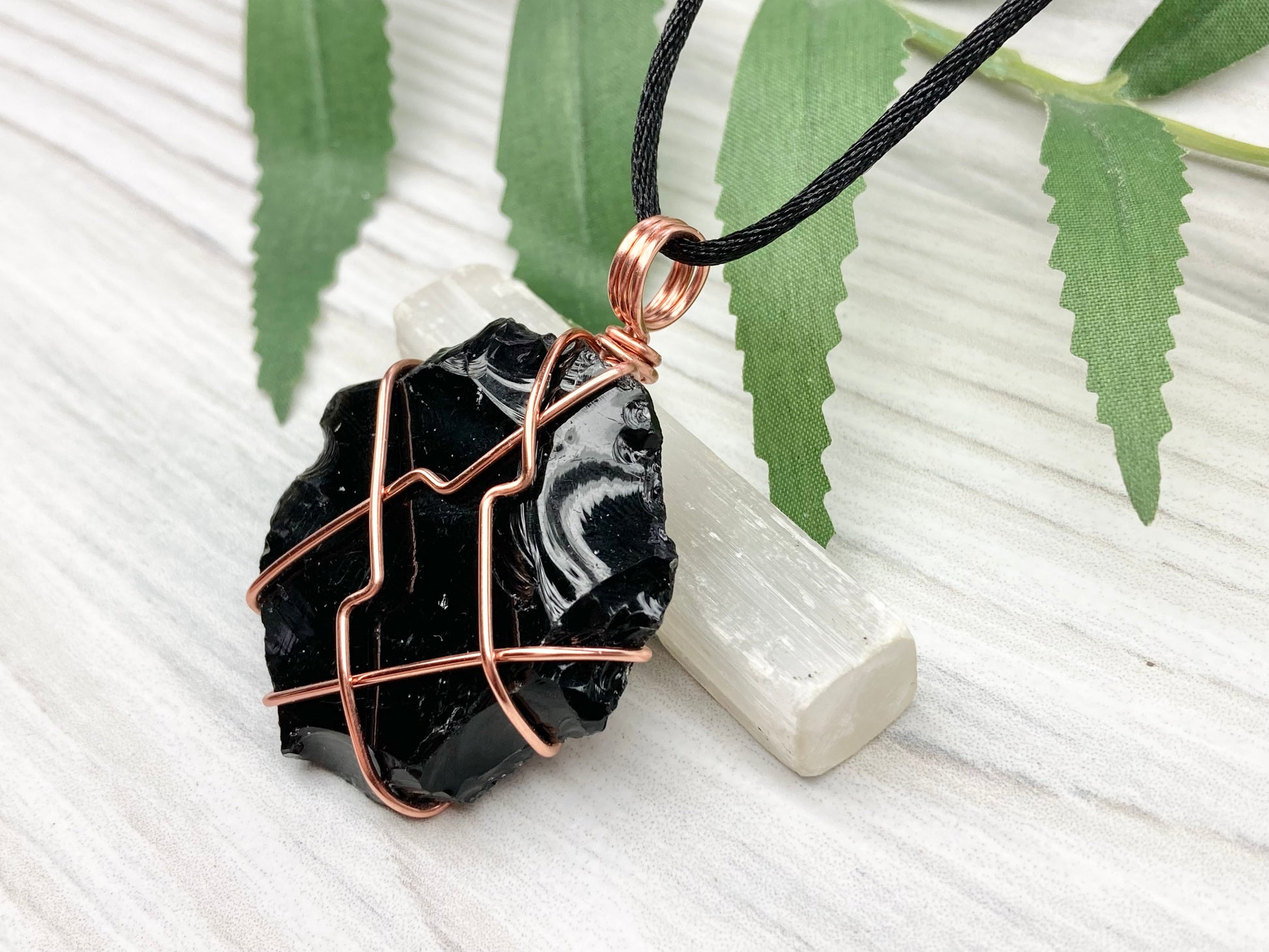 Raw black obsidian necklace. Natural black crystal wrapped with copper wire. Comes on a black necklace.