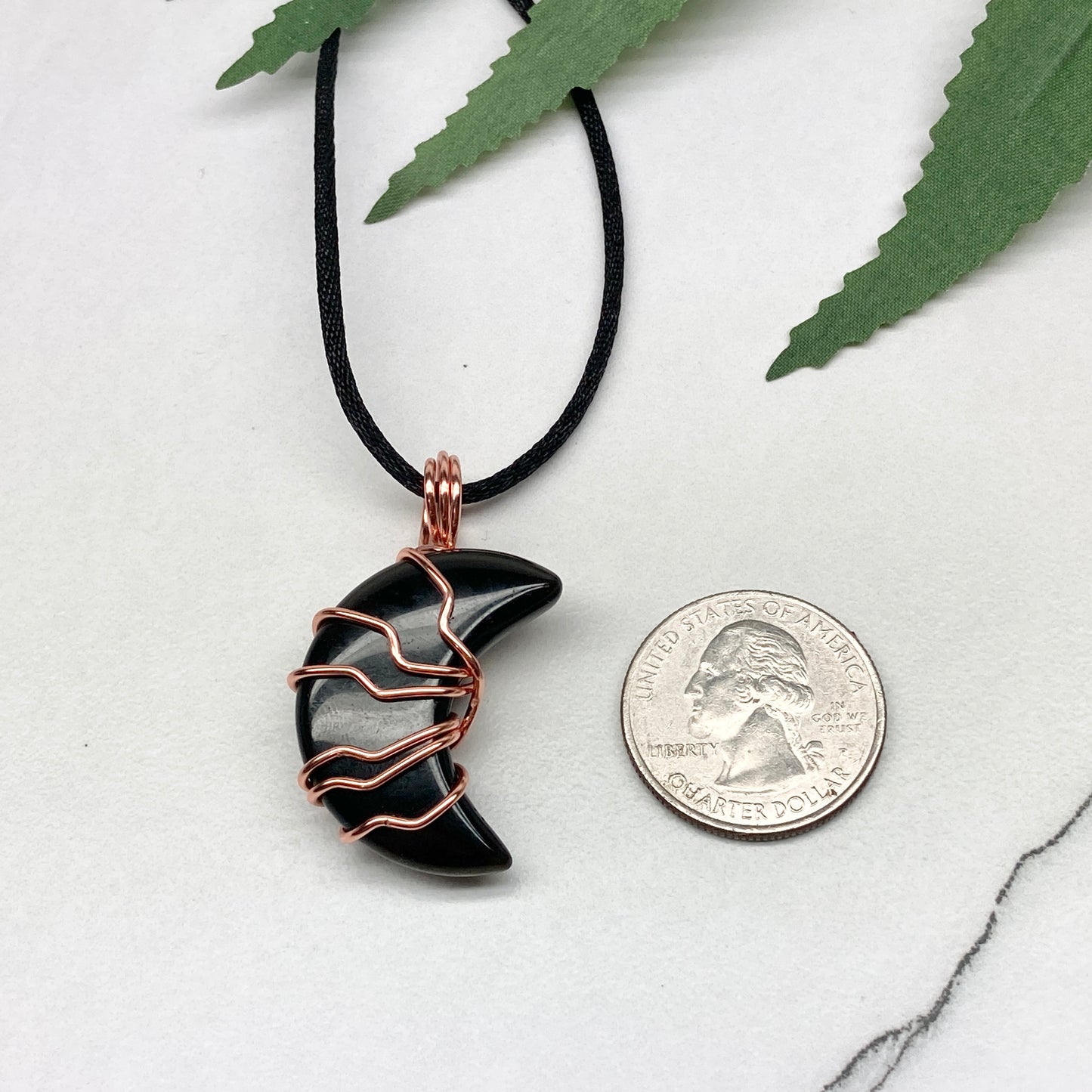 Black Onyx Moon necklace. Moon shaped Black Onyx crystal wrapped with tarnish resistant copper wire. Hangs on a black chain. Celestial Jewelry.