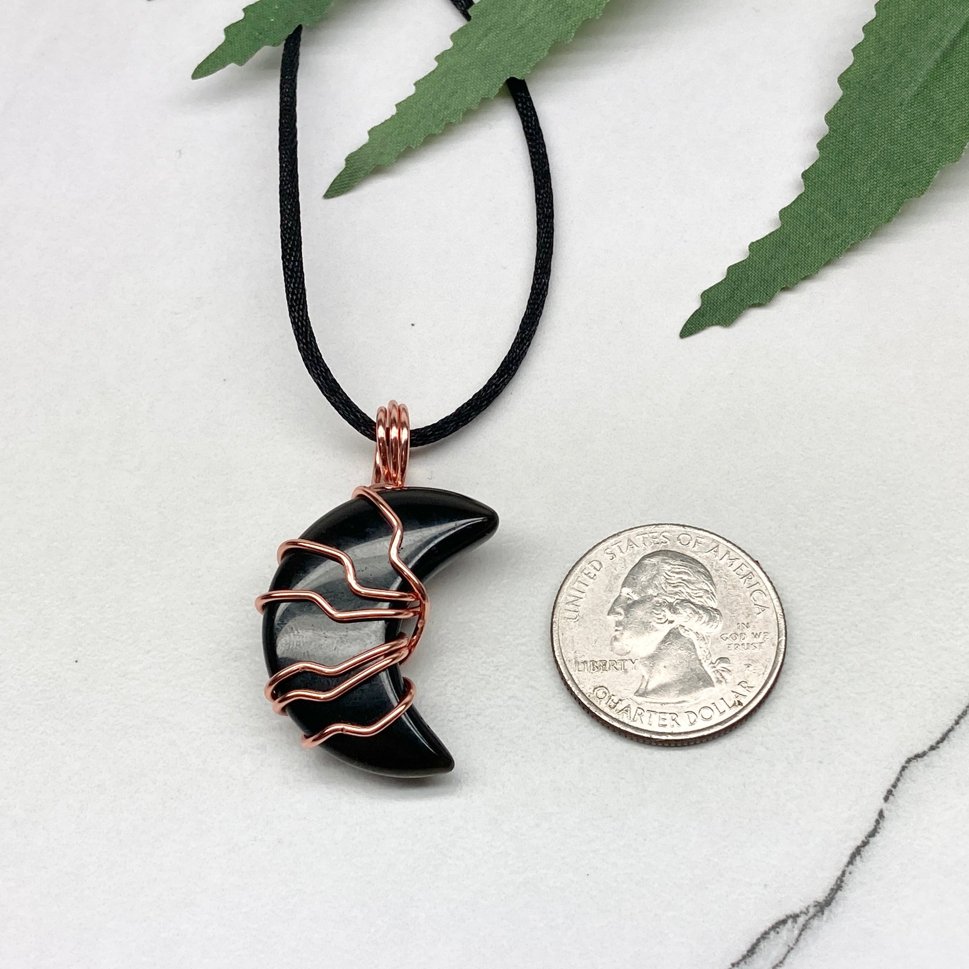 Black Onyx Moon necklace. Moon shaped Black Onyx crystal wrapped with tarnish resistant copper wire. Hangs on a black chain. Celestial Jewelry.