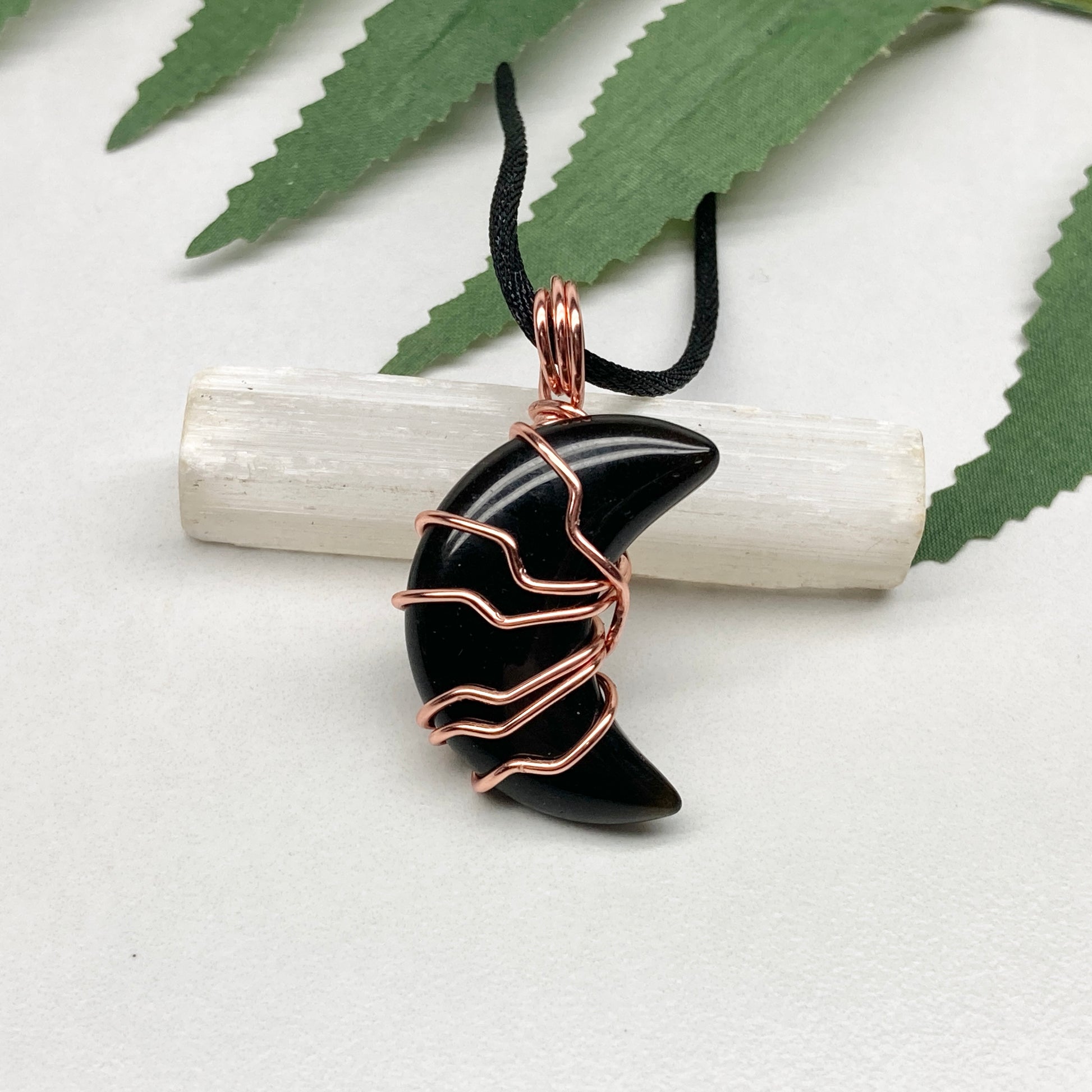 Black Onyx Moon necklace. Moon shaped Black Onyx crystal wrapped with tarnish resistant copper wire. Hangs on a black chain. Celestial Jewelry.