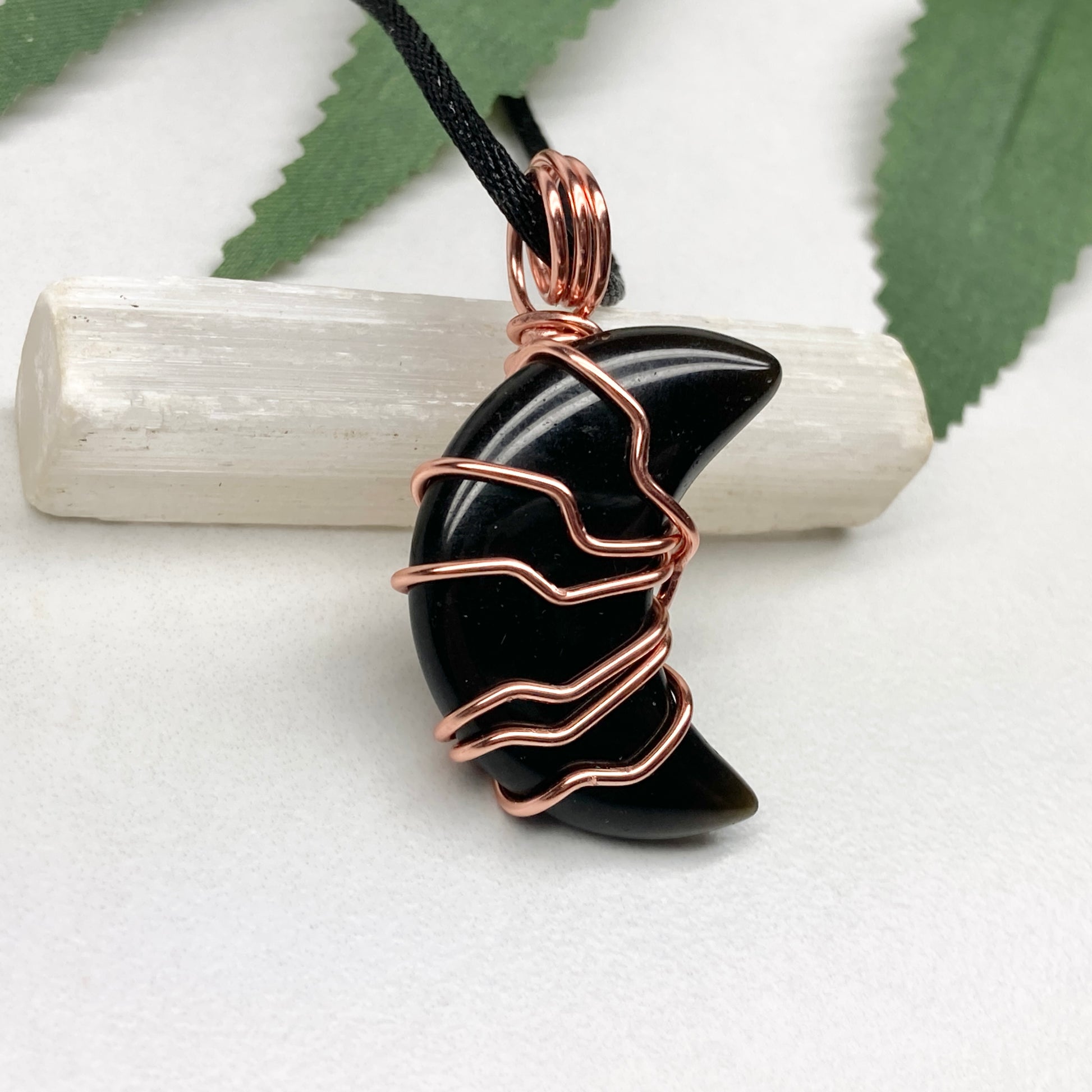 Black Onyx Moon necklace. Moon shaped Black Onyx crystal wrapped with tarnish resistant copper wire. Hangs on a black chain. Celestial Jewelry.