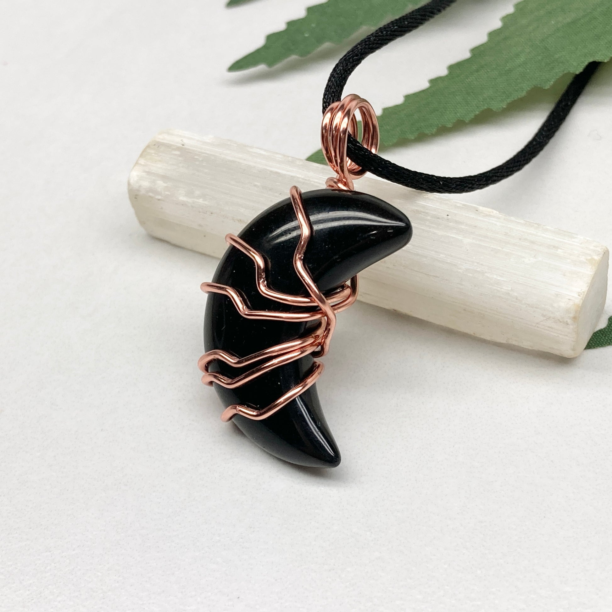 Black Onyx Moon necklace. Moon shaped Black Onyx crystal wrapped with tarnish resistant copper wire. Hangs on a black chain. Celestial Jewelry.