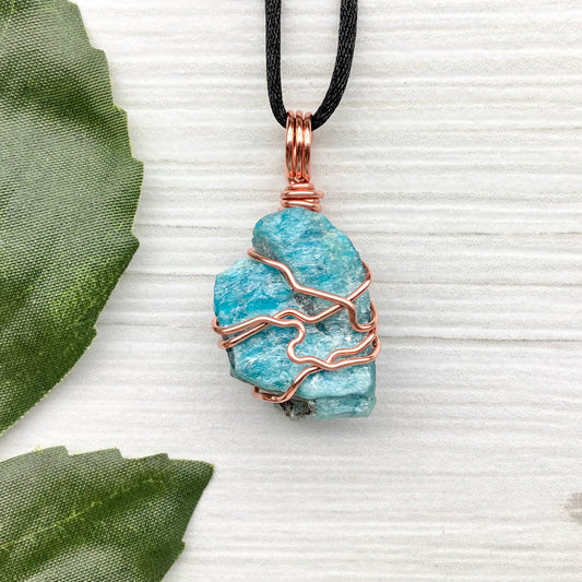 Blue Apatite Necklace. Raw Blue Apatite Stone Wrapped With Tarnish Resistant Copper Wire. This Pendant Was Handcrafted During The Moon In Scorpio. Comes On A Black Chain. Spiritual Jewelry For Him Or Her.
