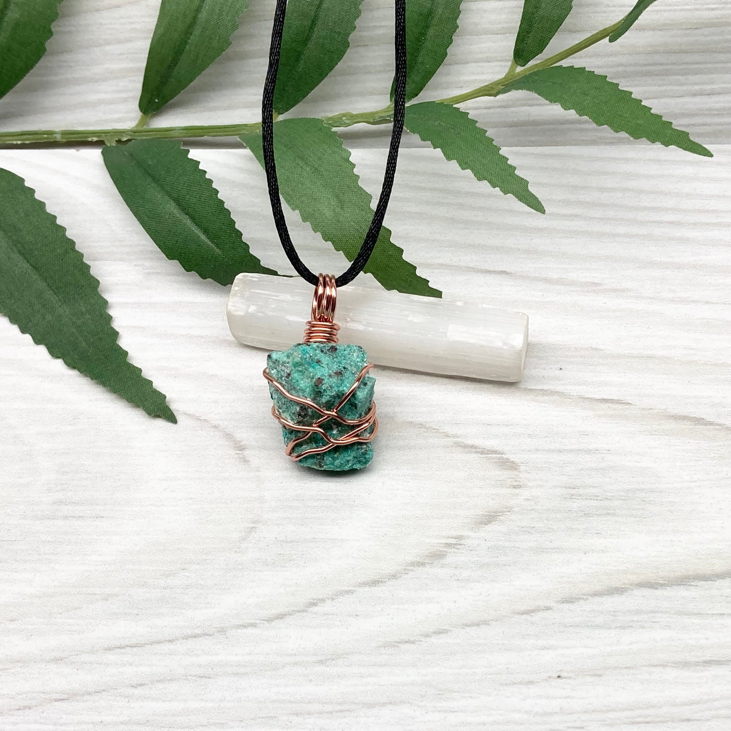 Chrysocolla necklace. Raw blue green stone wrapped in copper wire. Pendant hangs on a satin silk chain.