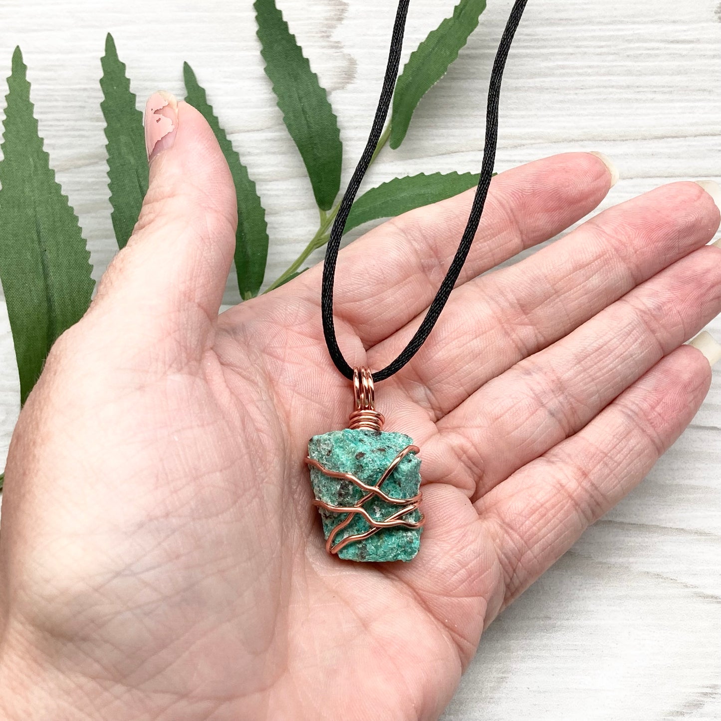 Chrysocolla necklace. Raw blue green stone wrapped in copper wire. Pendant hangs on a satin silk chain.