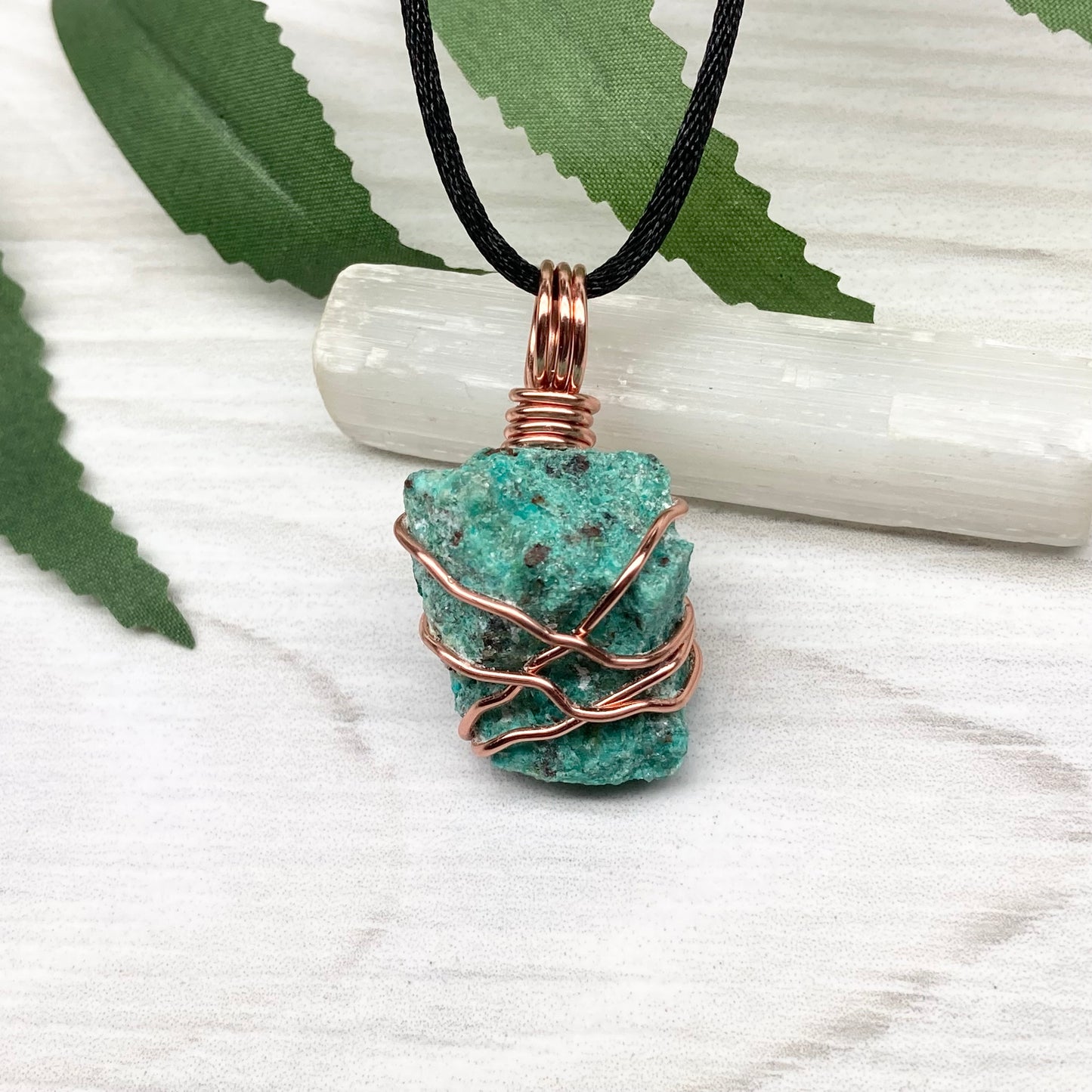 Chrysocolla necklace. Raw blue green stone wrapped in copper wire. Pendant hangs on a satin silk chain.