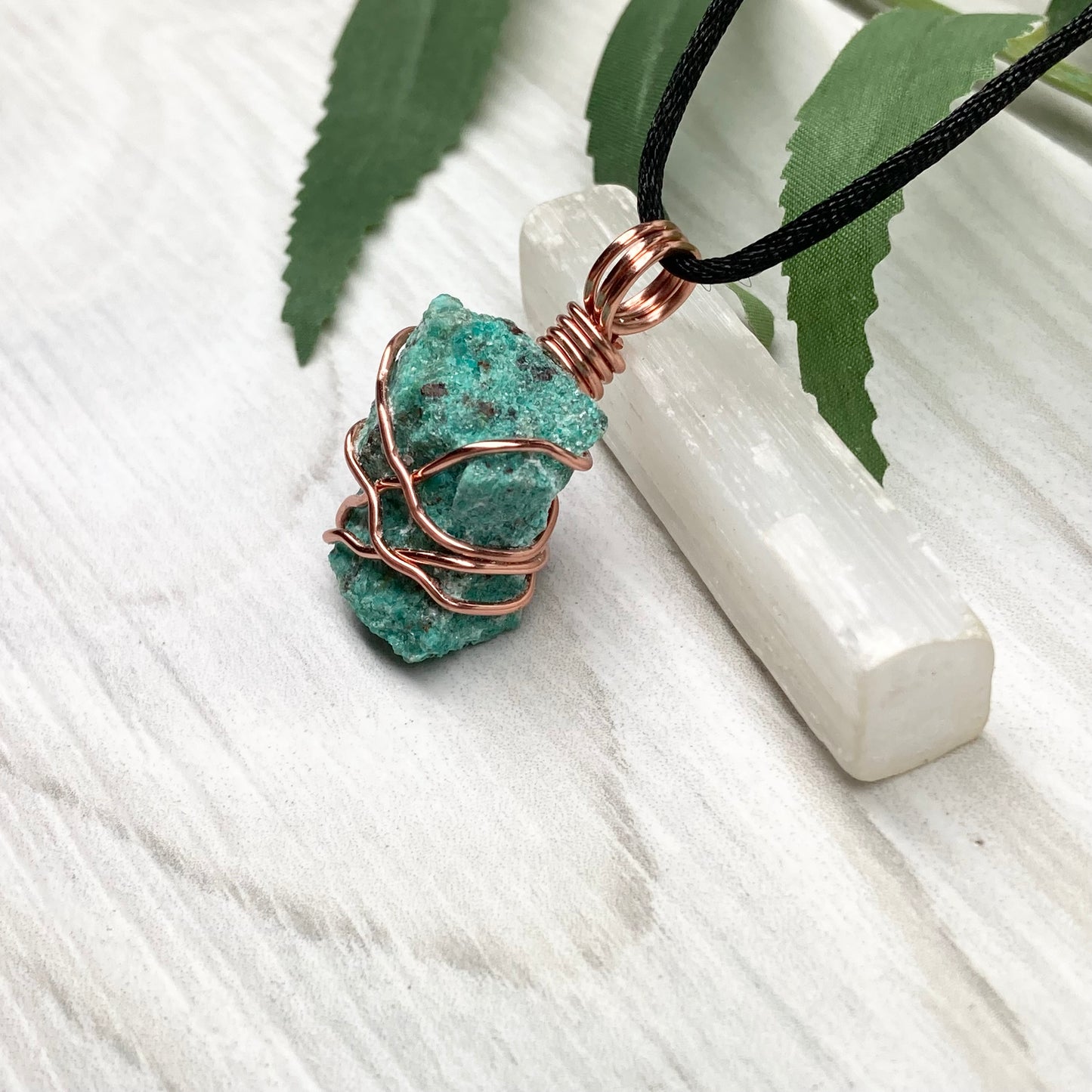 Chrysocolla necklace. Raw blue green stone wrapped in copper wire. Pendant hangs on a satin silk chain.