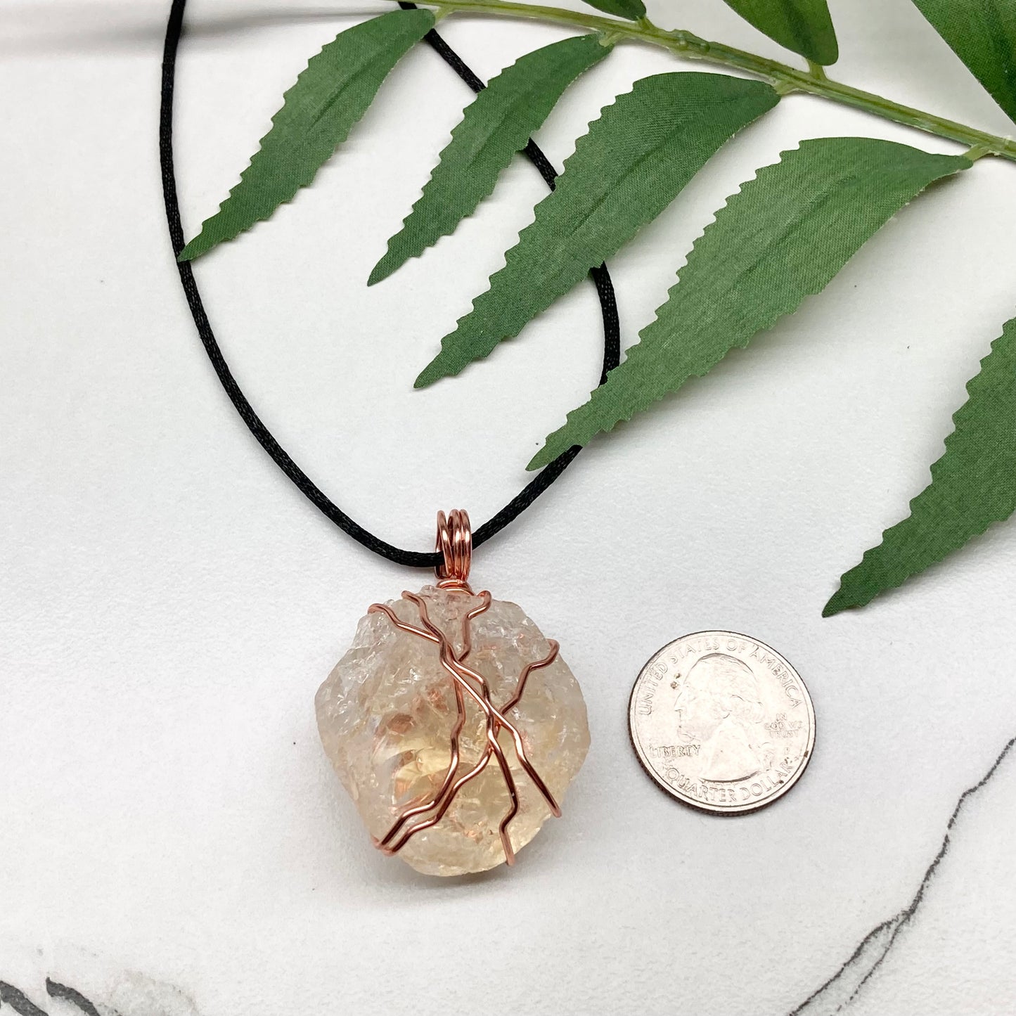 Chunky Citrine necklace. Light yellow crystal wrapped with pure copper wire. hangs on a black chain. 
