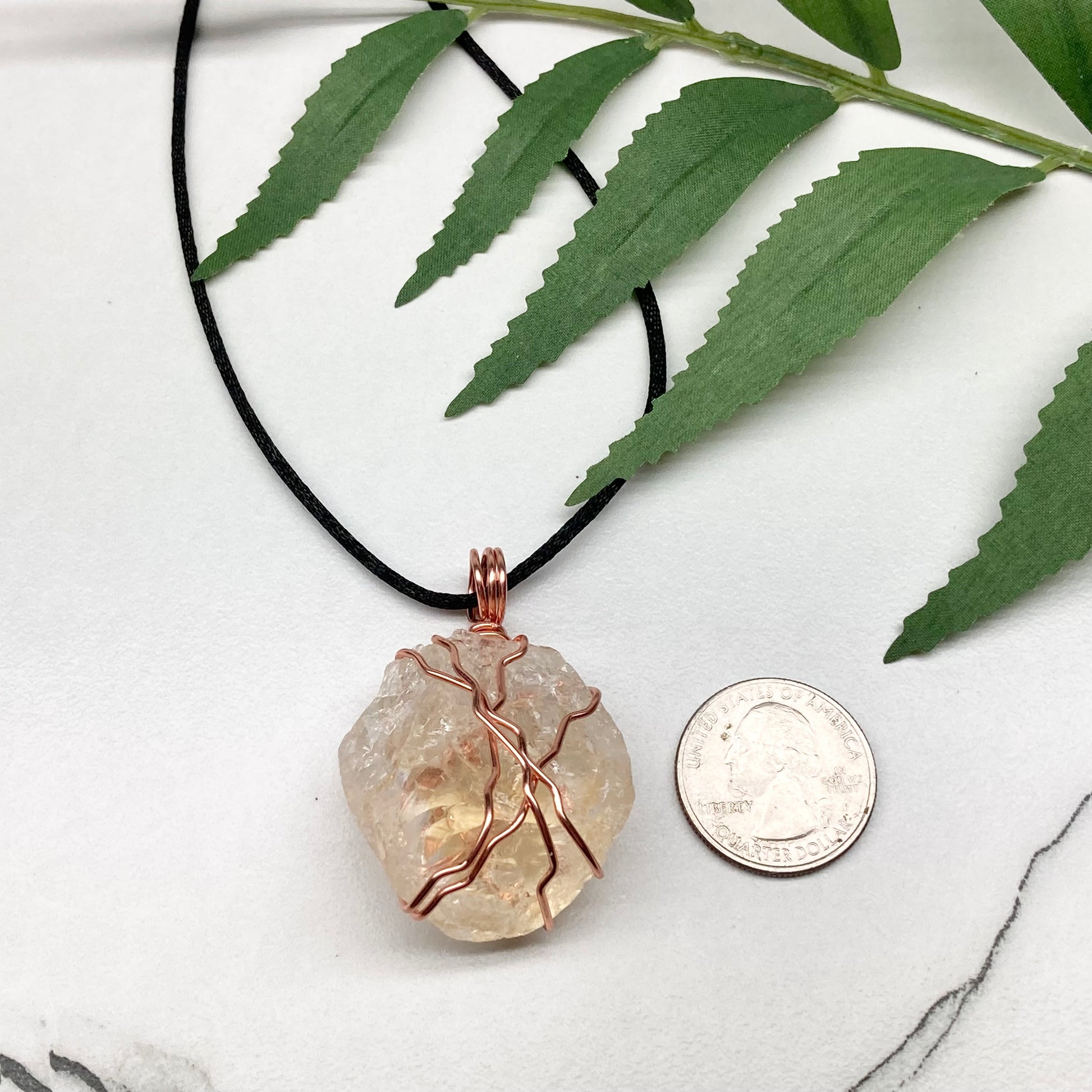 Chunky Citrine necklace. Light yellow crystal wrapped with pure copper wire. hangs on a black chain. 