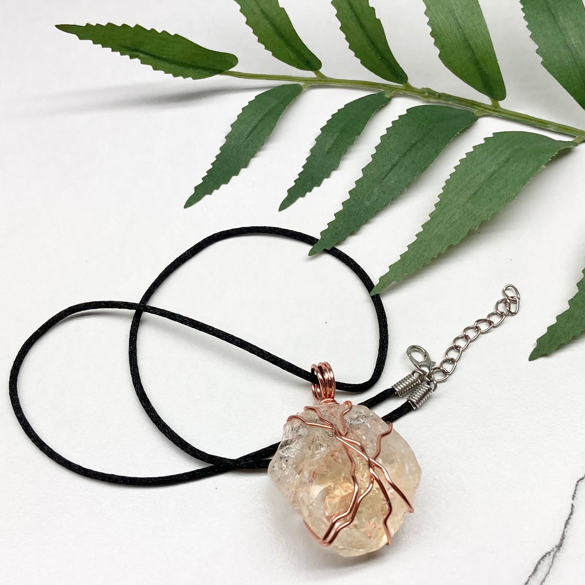 Chunky Citrine necklace. Light yellow crystal wrapped with pure copper wire. hangs on a black chain. 