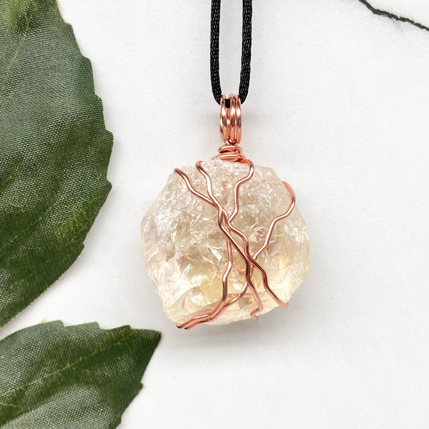 Chunky Citrine necklace. Light yellow crystal wrapped with pure copper wire. hangs on a black chain. 