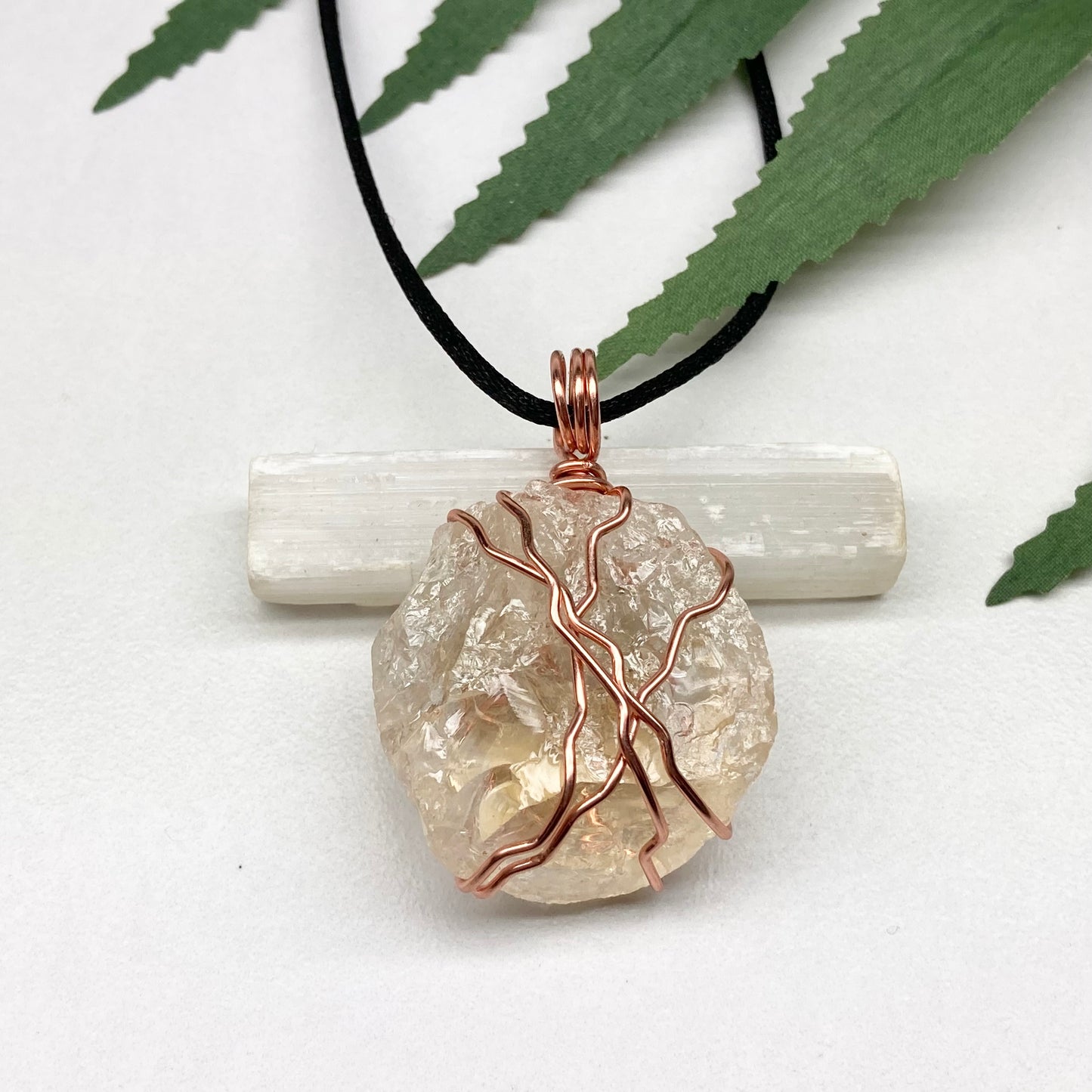 Chunky Citrine necklace. Light yellow crystal wrapped with pure copper wire. hangs on a black chain. 