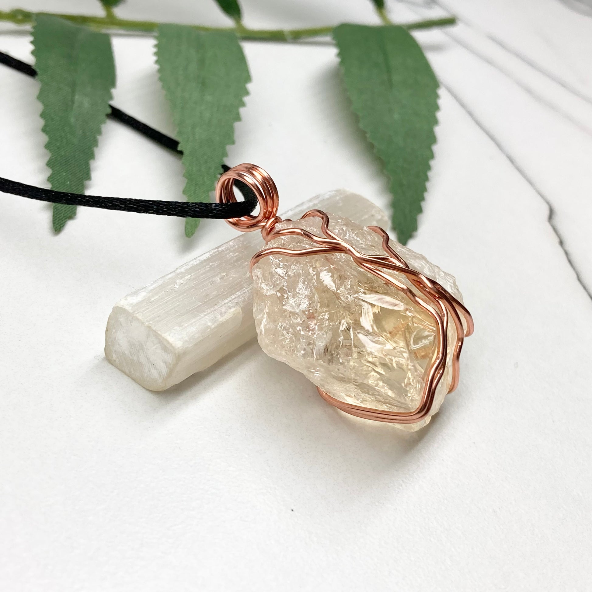 Chunky Citrine necklace. Light yellow crystal wrapped with pure copper wire. hangs on a black chain. 