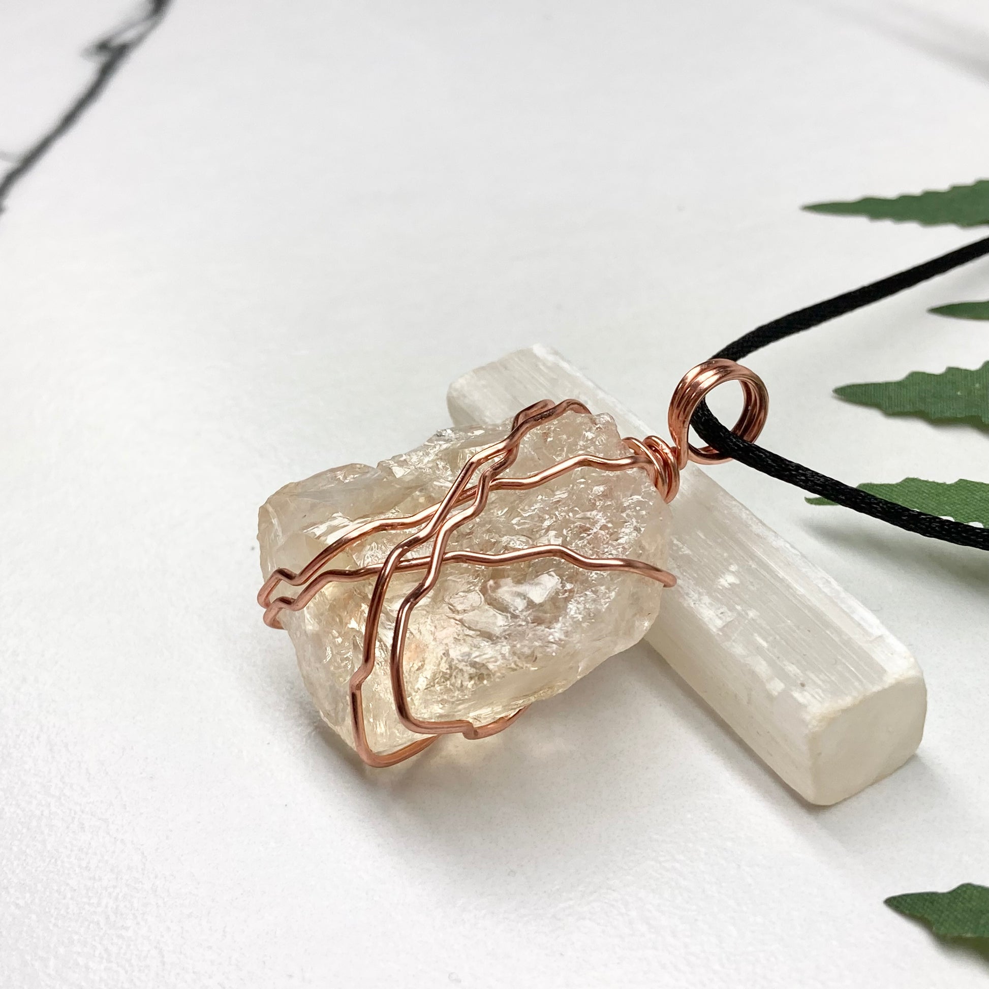 Chunky Citrine necklace. Light yellow crystal wrapped with pure copper wire. hangs on a black chain. 